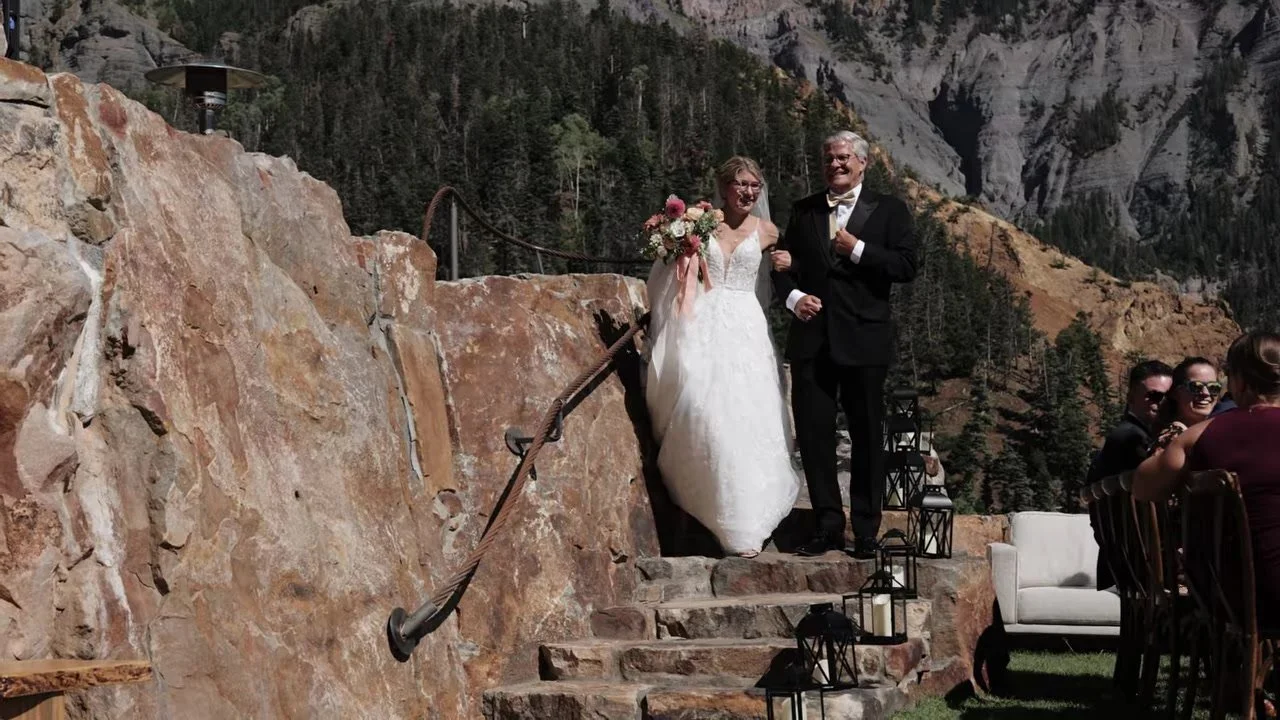 Madeline on the stone stairs with her father in a gold bow tie at Gold Mountain, Ouray
