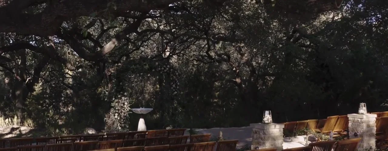Empty ceremony under live oaks at Sacred Oaks, Camp Lucy, from an Adam Grumbo wedding film