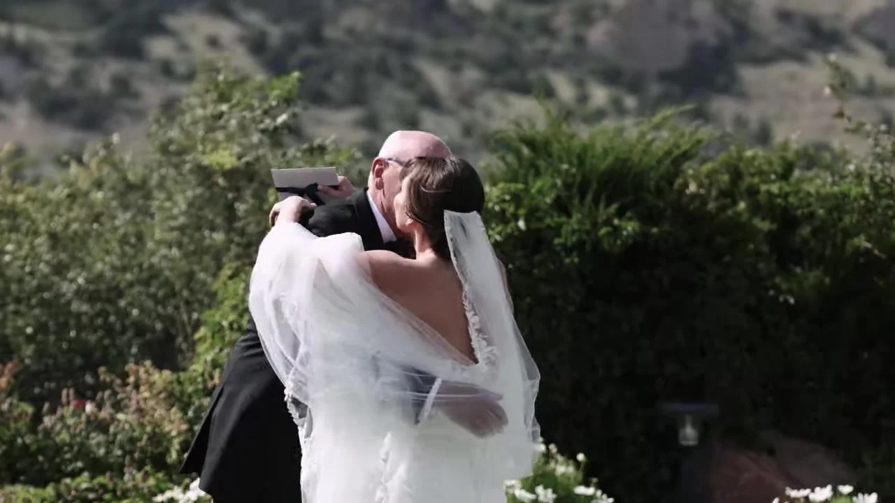Susanne in a father-daughter embrace on the resort lawn at Garden of the Gods