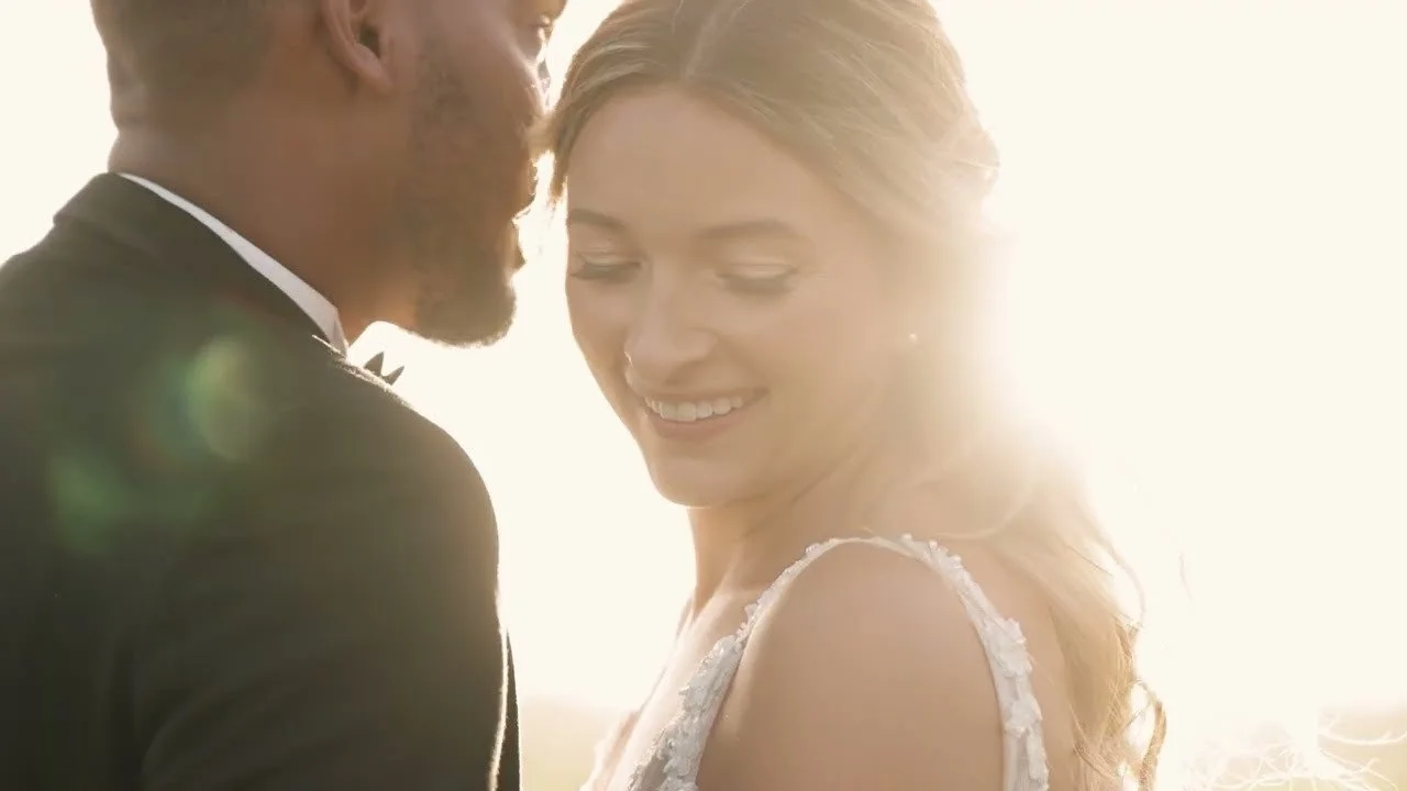 Felix leaning in as Victoria smiles in late Dominican sun, floral lace on her strap