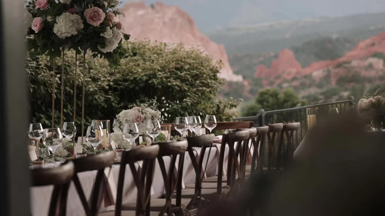Outdoor reception tables with florals and Garden of the Gods red rocks