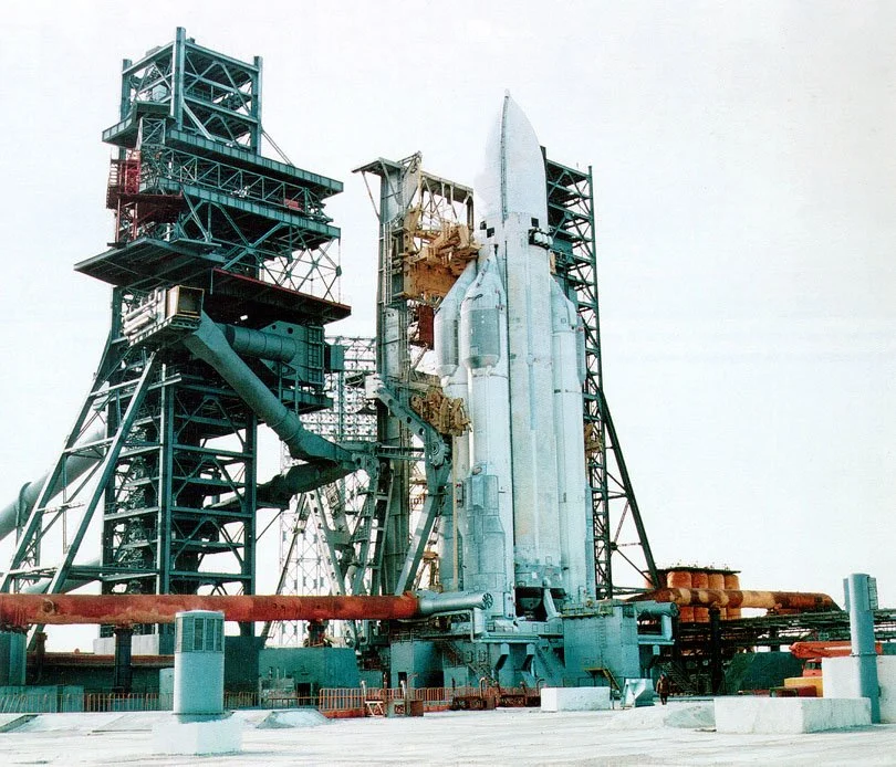 A Energia on a launch pad surrounded by structural support towers and equipment.