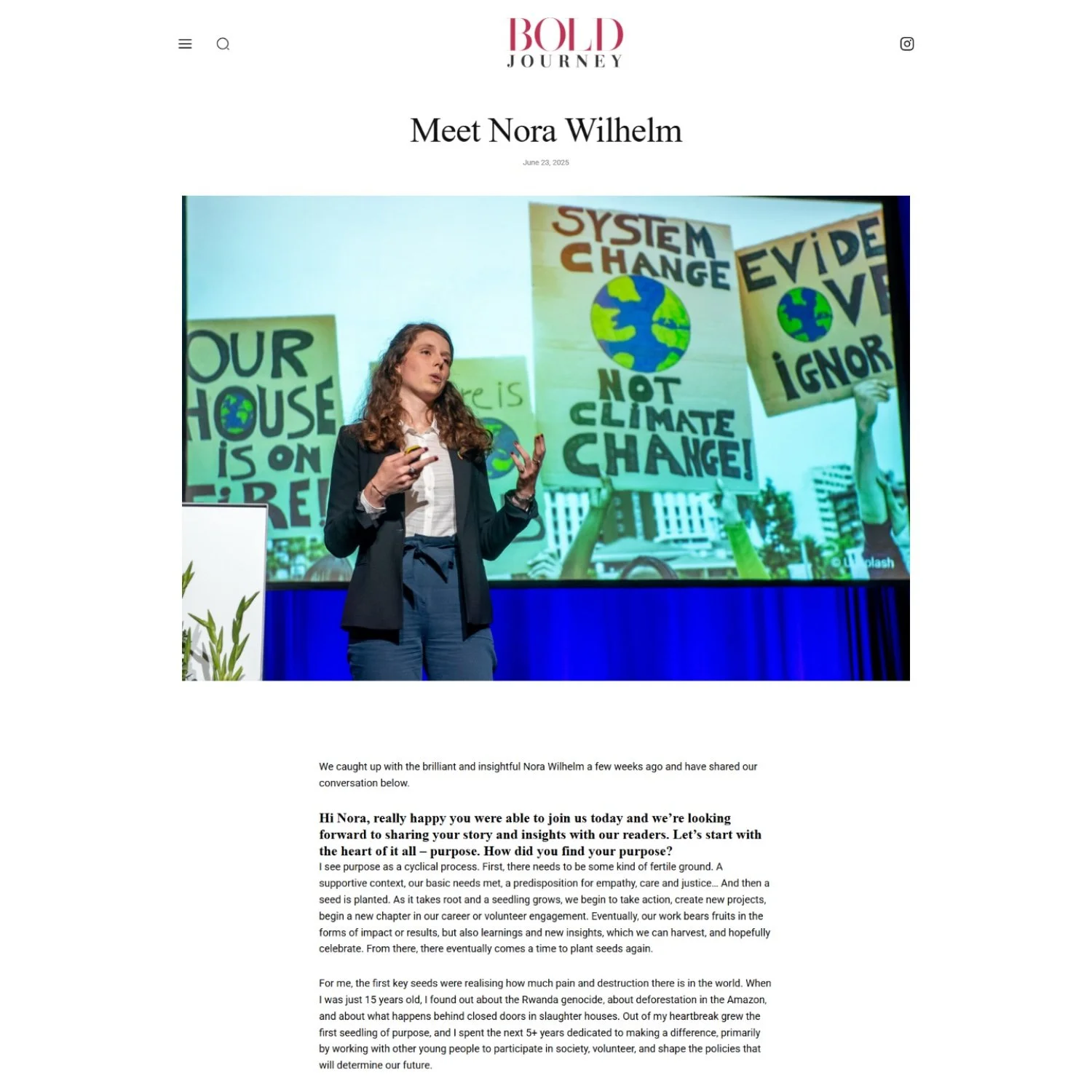 A woman giving a speech at a conference with posters of climate change protests in the background.