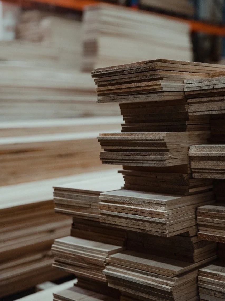 Stacks of wooden planks in a lumber storage area.