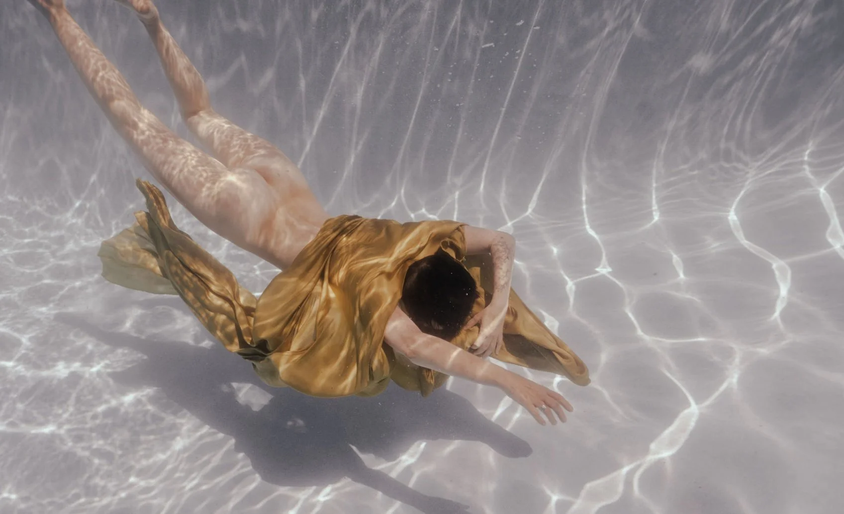 Women diving in pool naked