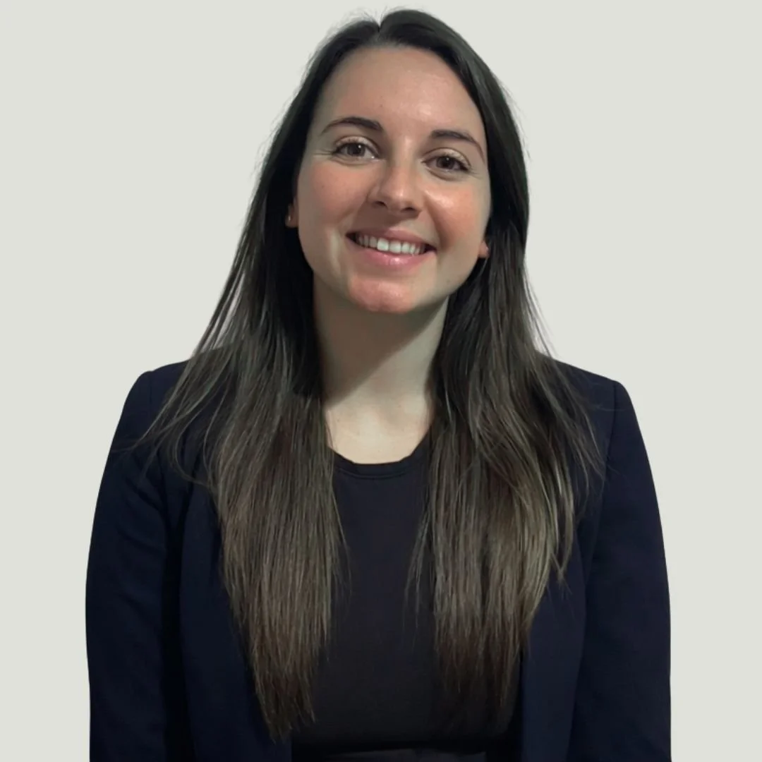 A Headshot of Heather in a navy blue blazer, smiling