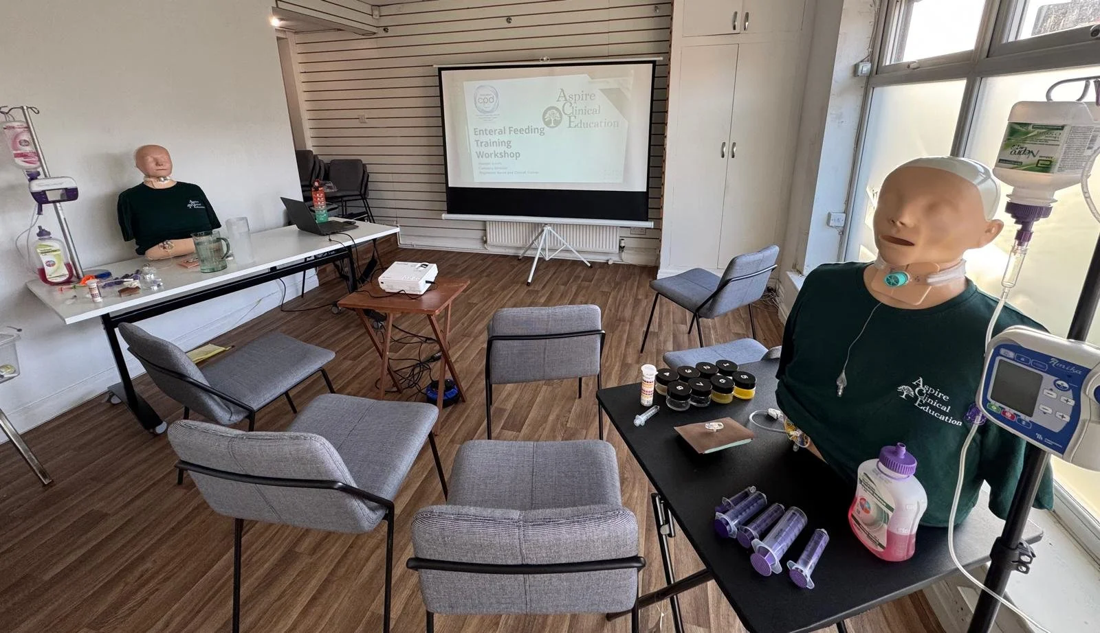 Set up of a PEG feeding workshop featuring projector, chairs and simulation workstations