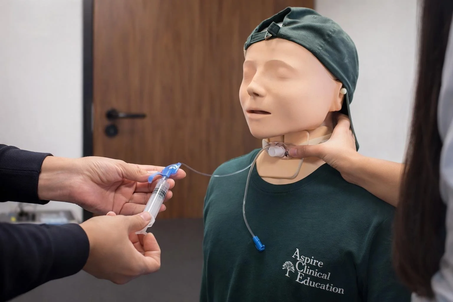 learner practicing deflating a cuff of a portex tracheostomy