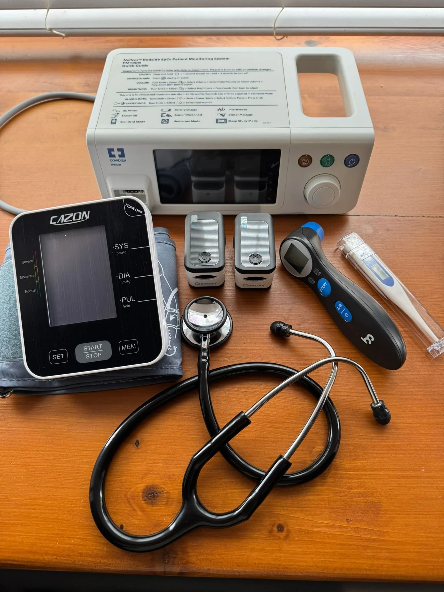 BP machine, stethoscope, temperature tympanic and oxygen monitors display