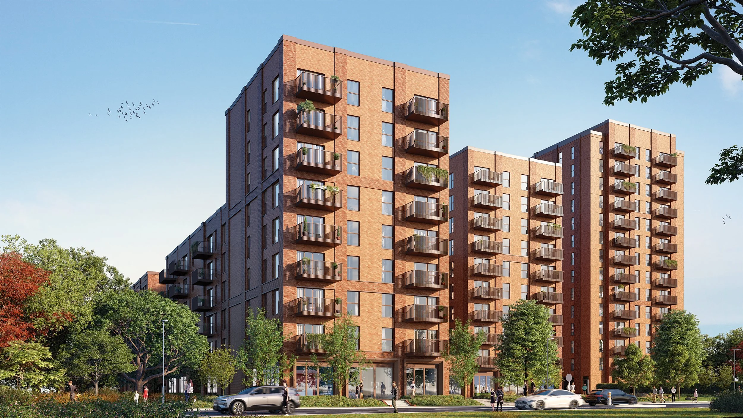 A modern multi-story apartment building with brick exterior and balconies, surrounded by greenery and people walking on the sidewalk, under a clear blue sky.