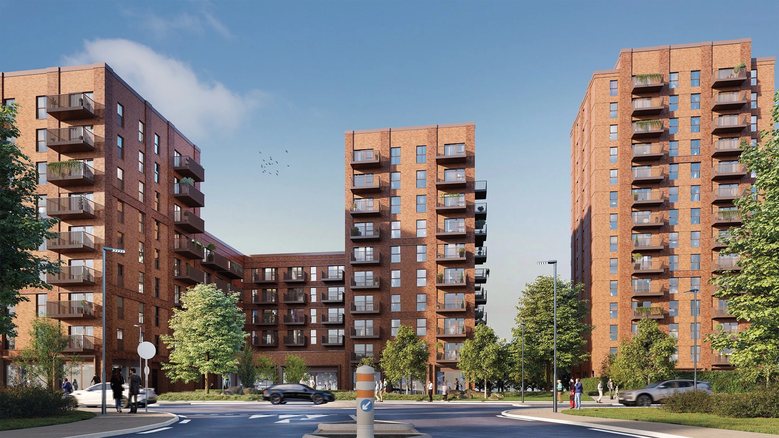 Modern red-brick residential apartment buildings with balconies on a city street, trees, streetlights, pedestrians, and cars under a clear blue sky.