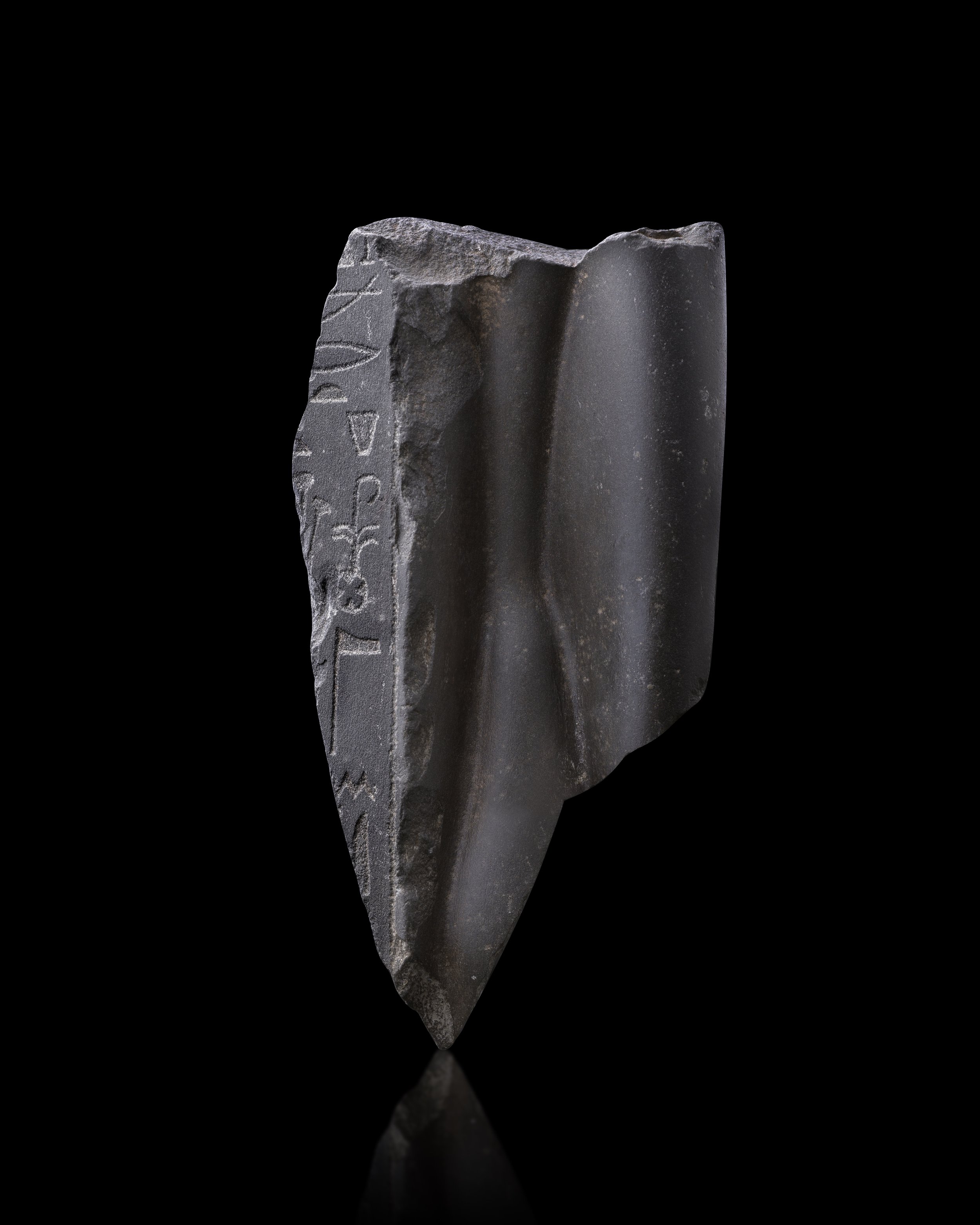  An Egyptian greywacke fragmentary torso of queen Arsinoe II,  , Ptolemaic Period, c. 316–270 BC 
greywacke 
height: 23.2 cm 
