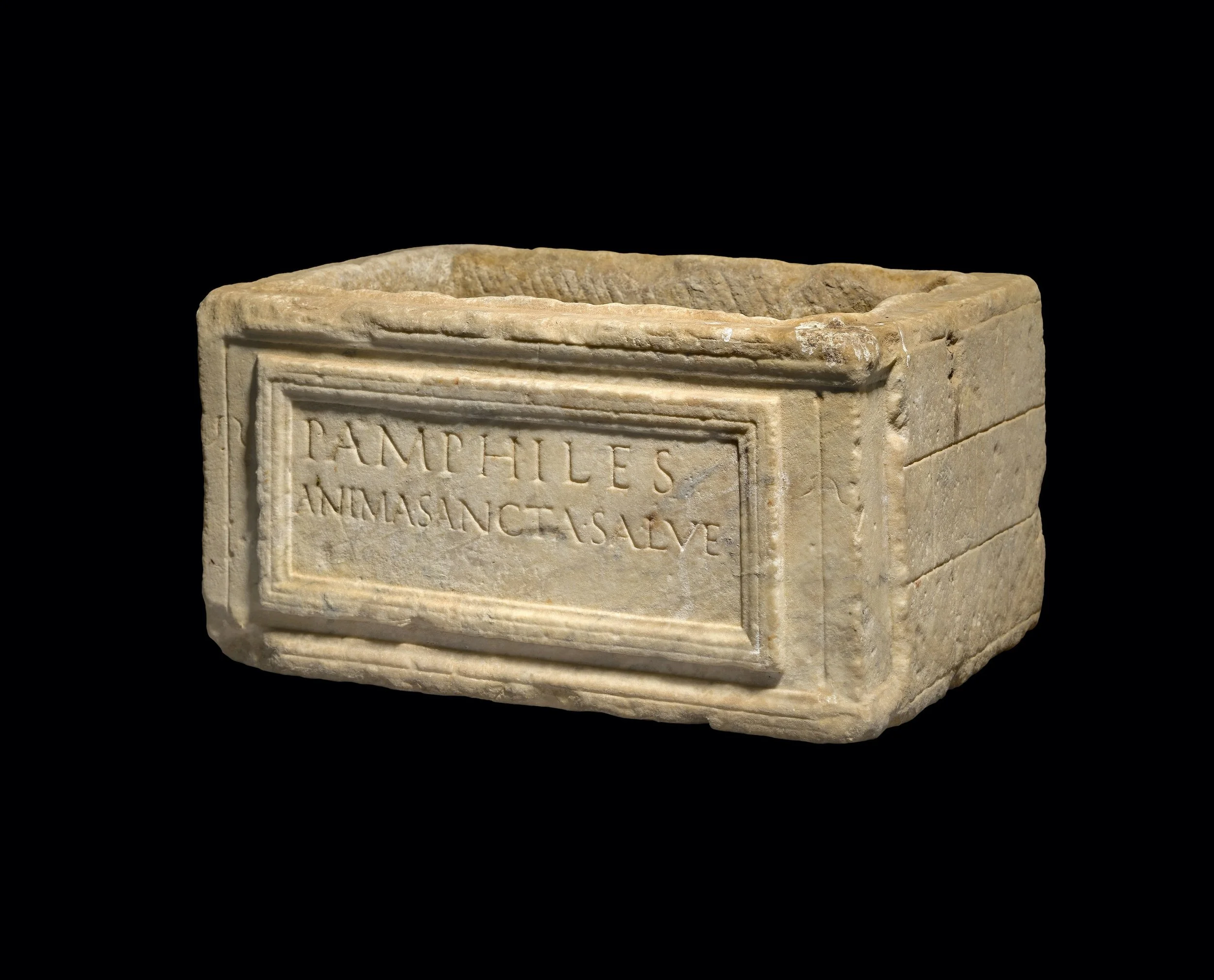  A Roman marble cinerary urn , c. 1st century AD 
inscribed ‚ ‘Hail Holy Soul of Pamphile’ 
marble  
height: 21.6 cm; length: 38.7 cm; diameter: 26.7 cm