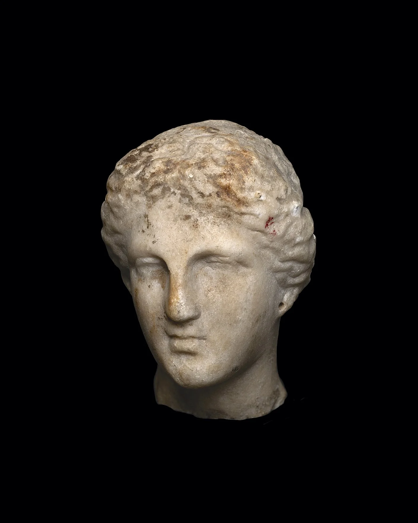  A Greek marble female head , Hellenistic, c. 4th–3rd century BC 
marble 
height: 12 cm 
