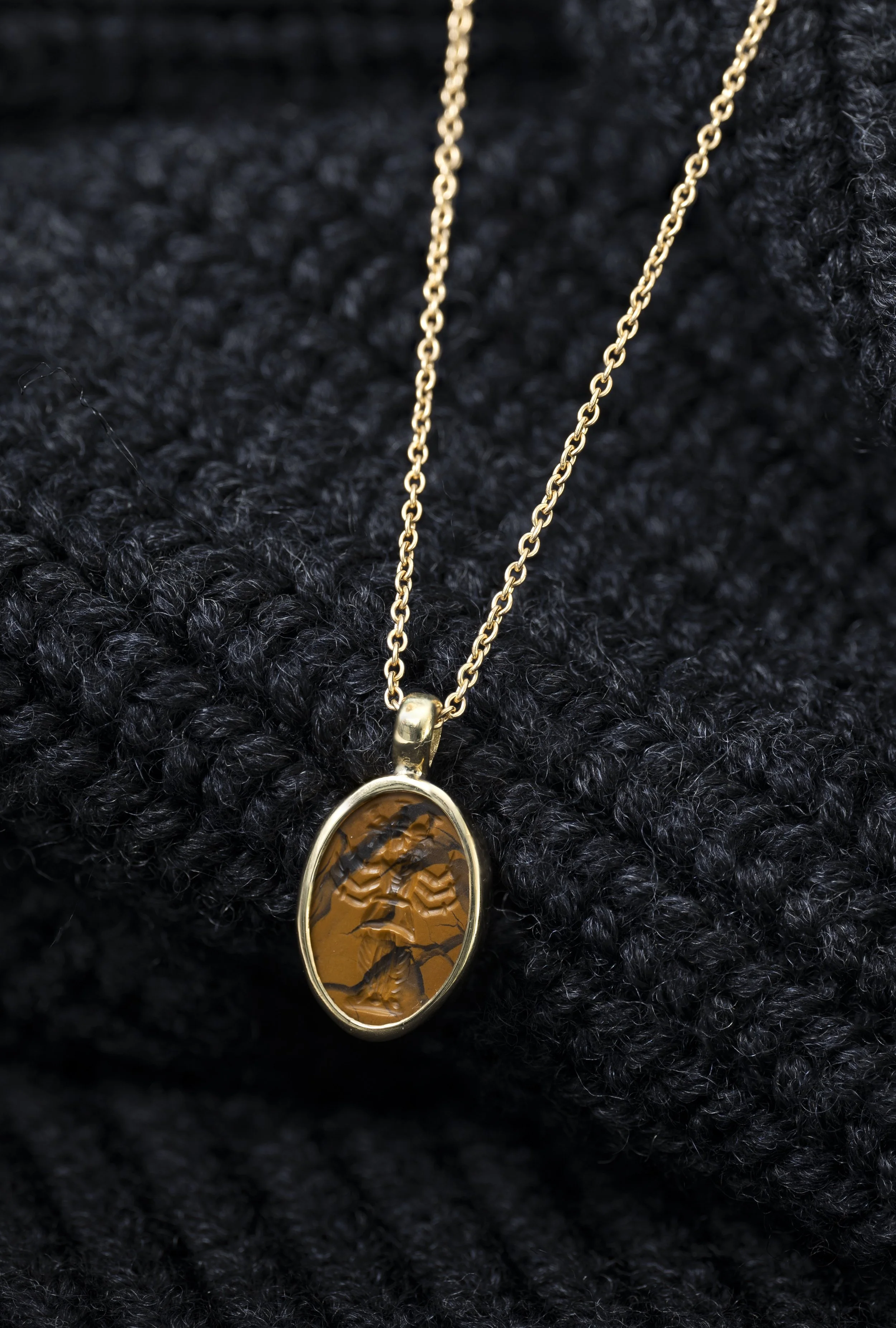  A Roman yellow jasper intaglio of Hekate set in a modern gold pendant , c. 2nd–3rd century AD 
yellow jasper, gold  
length of intaglio: 1.3 cm