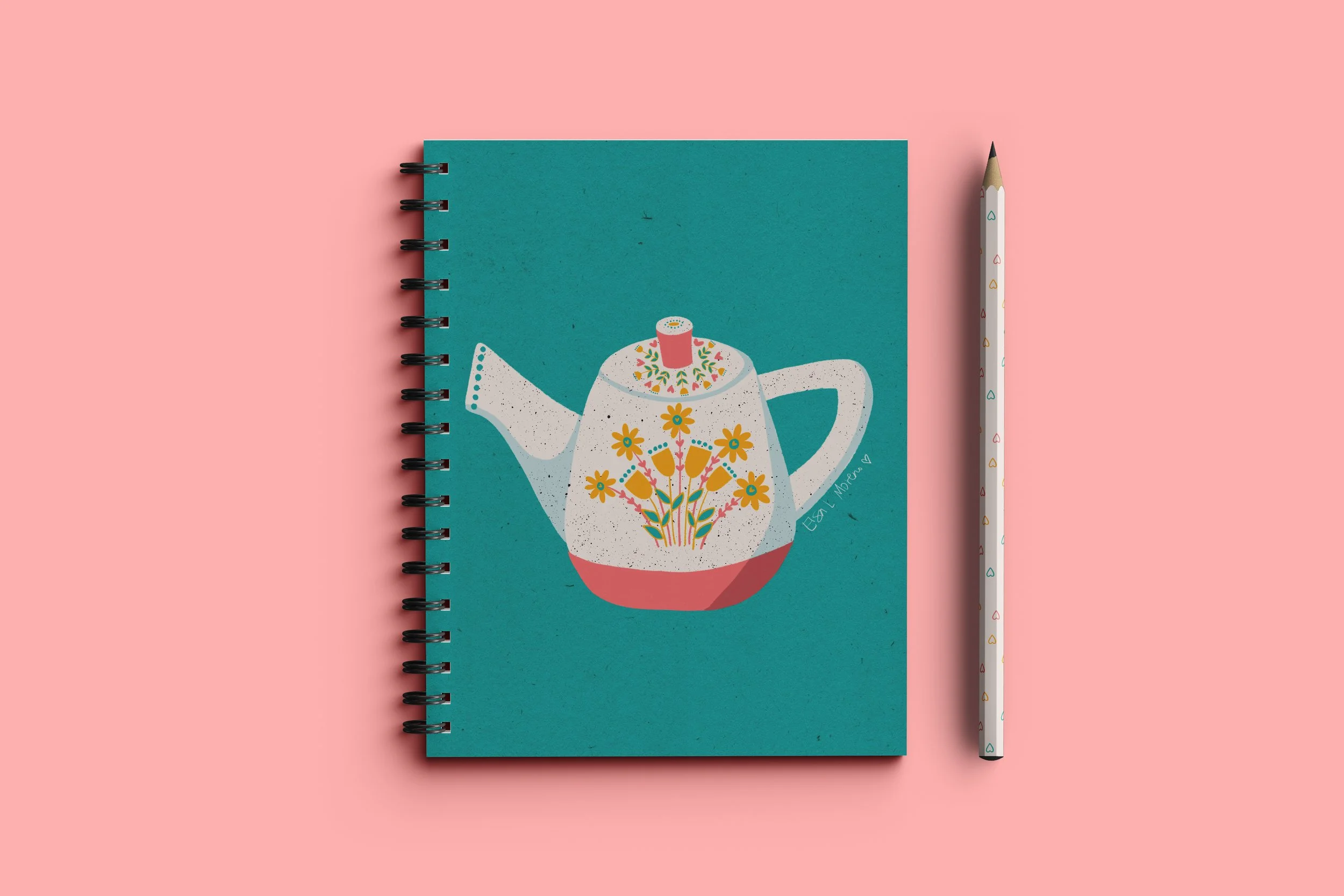 A teal notebook with spiral, depicting a teapot with yellow flowers and coral accents