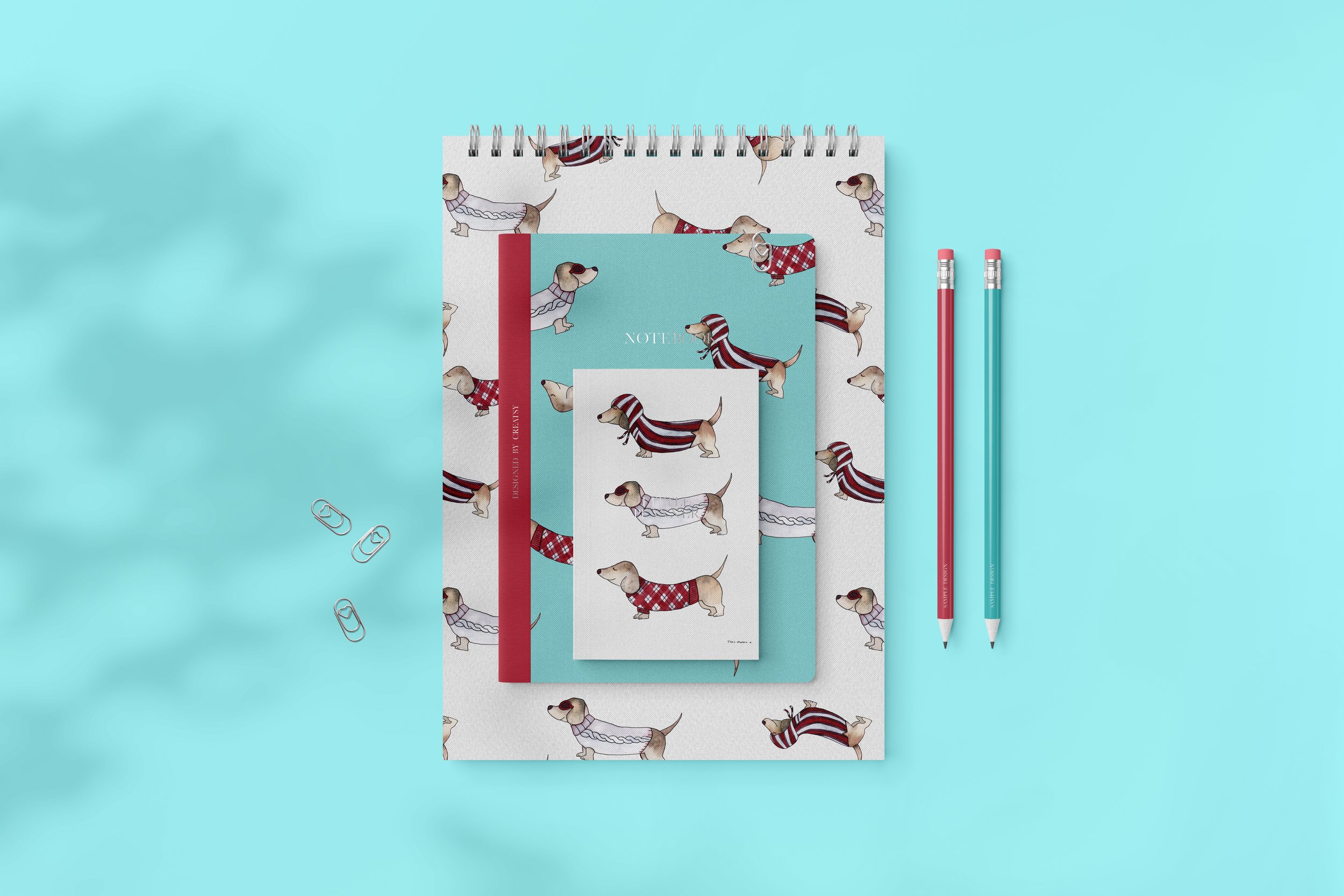 Three notepads depicting dachshunds in teal, burgundy and ecru tones