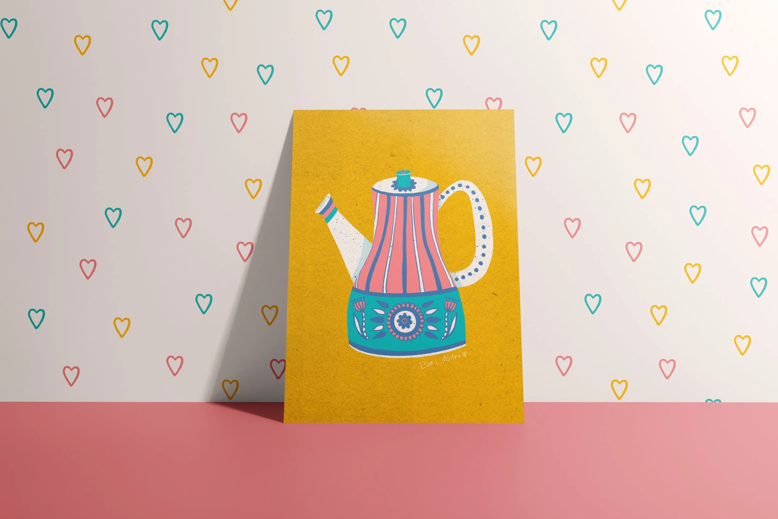 A card depicting a floral and striped teapot, standing against a wall with mini hearts wallpaper