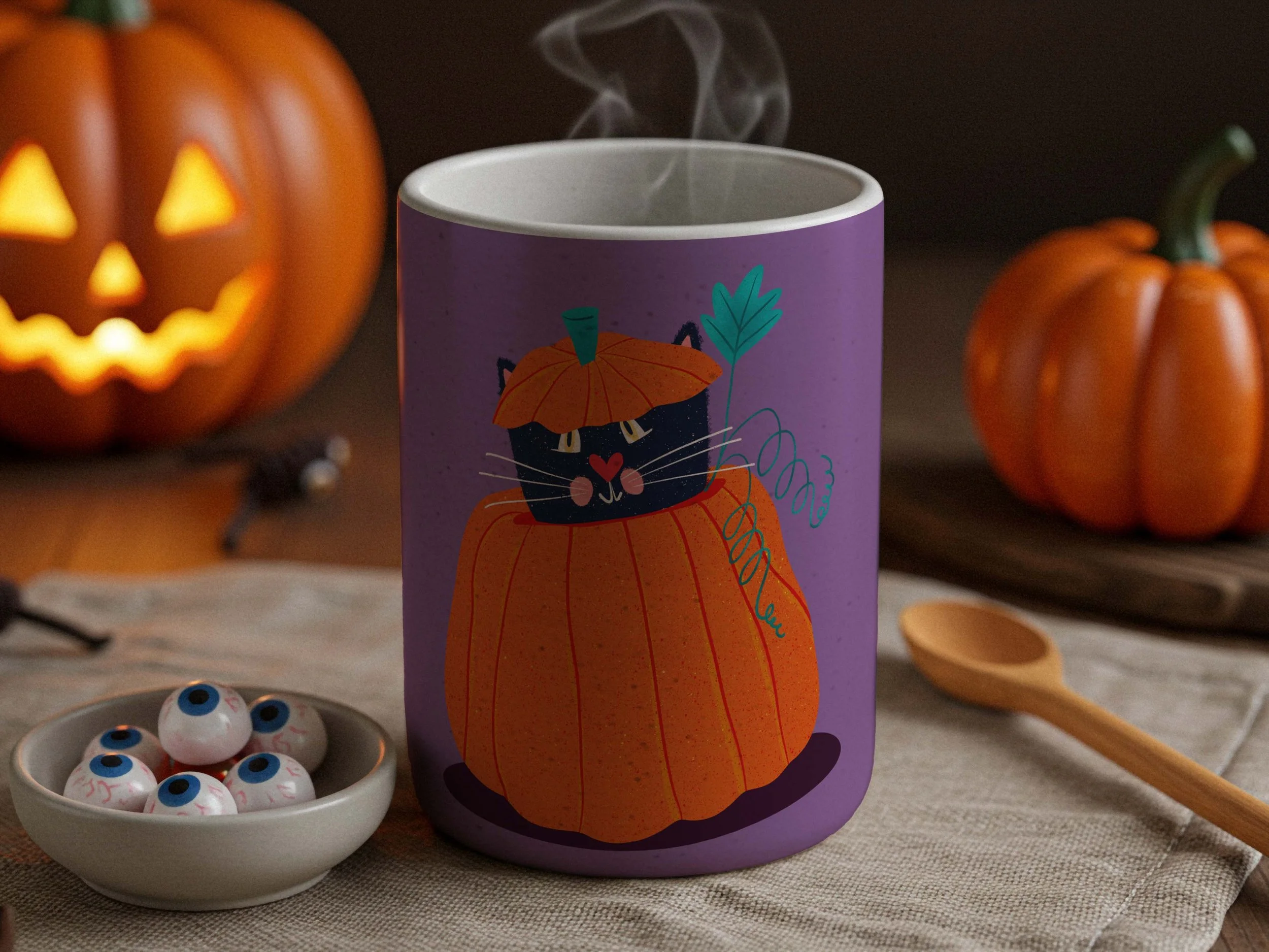 A purple Halloween mug depicting a black cat inside a pumpkin. The scene has two jack-o-lanterns and a plate with googly eyes on a table.