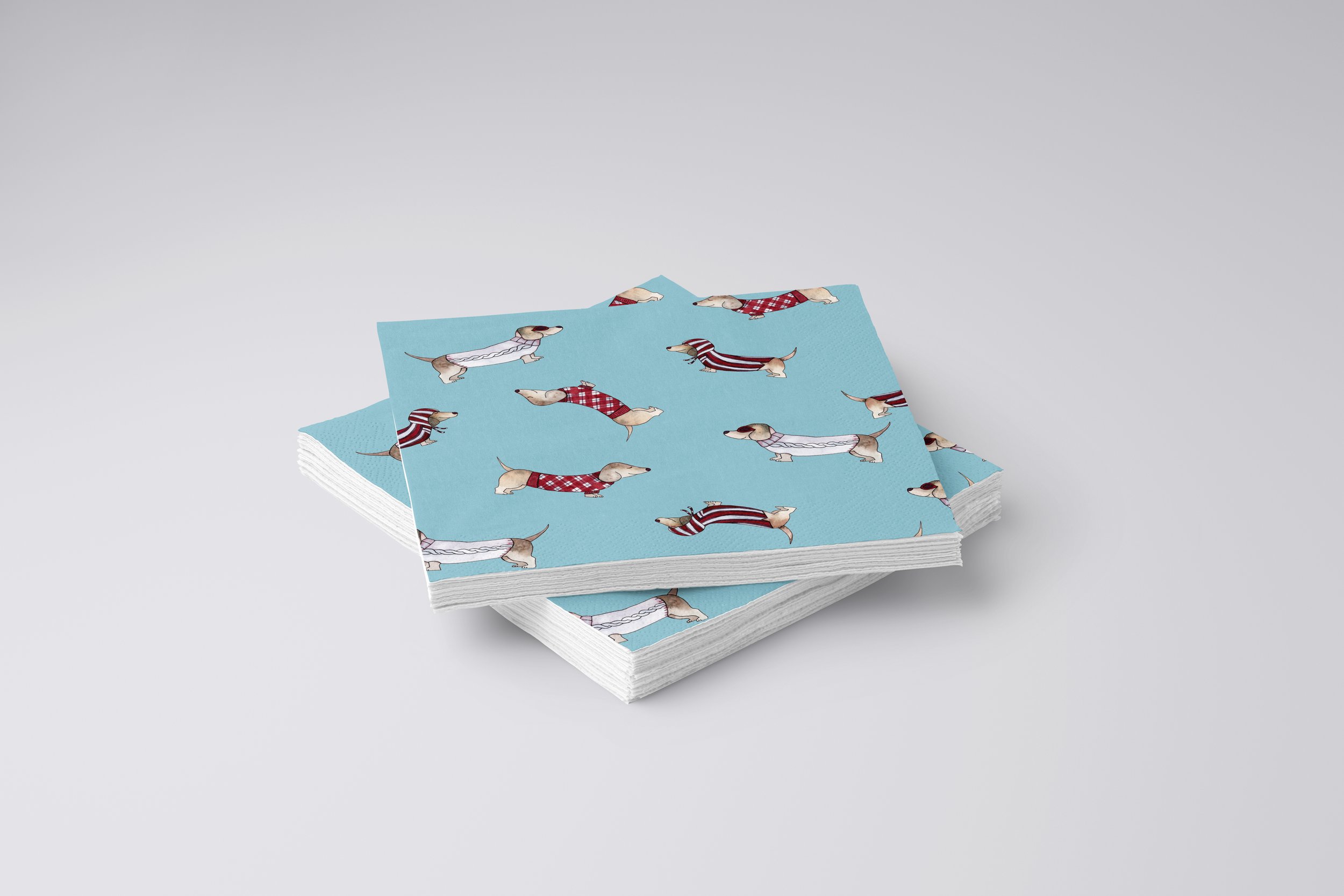 Napkins with a scatter pattern of dachshunds with an aqua background