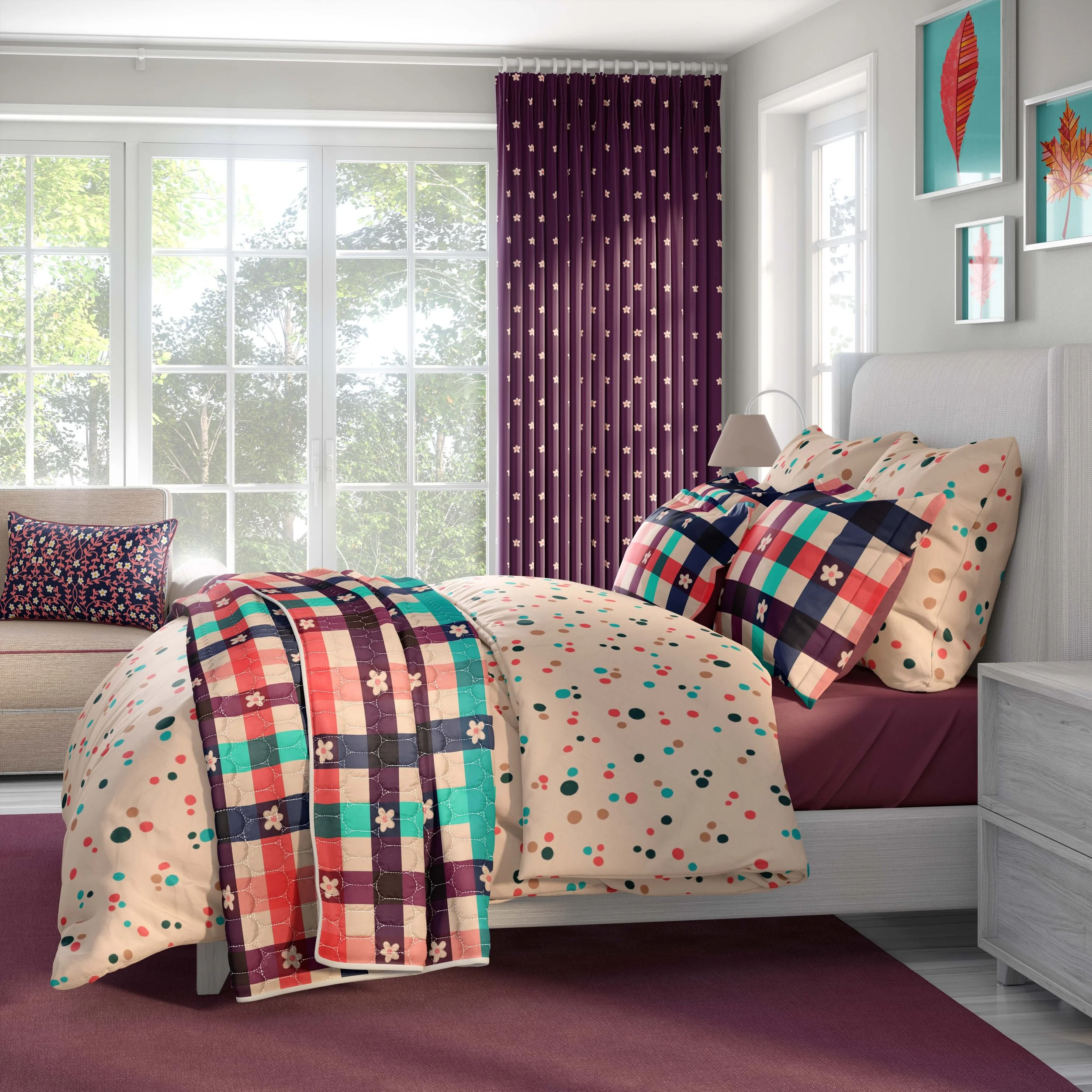 A bedroom featuring a bed with autumnal-colored repeating patterns. The wall features frames with autumnal leaves over turquoise backgrounds and the curtains in the window feature a floral motif over a burgundy background. There is a sofa with a cush