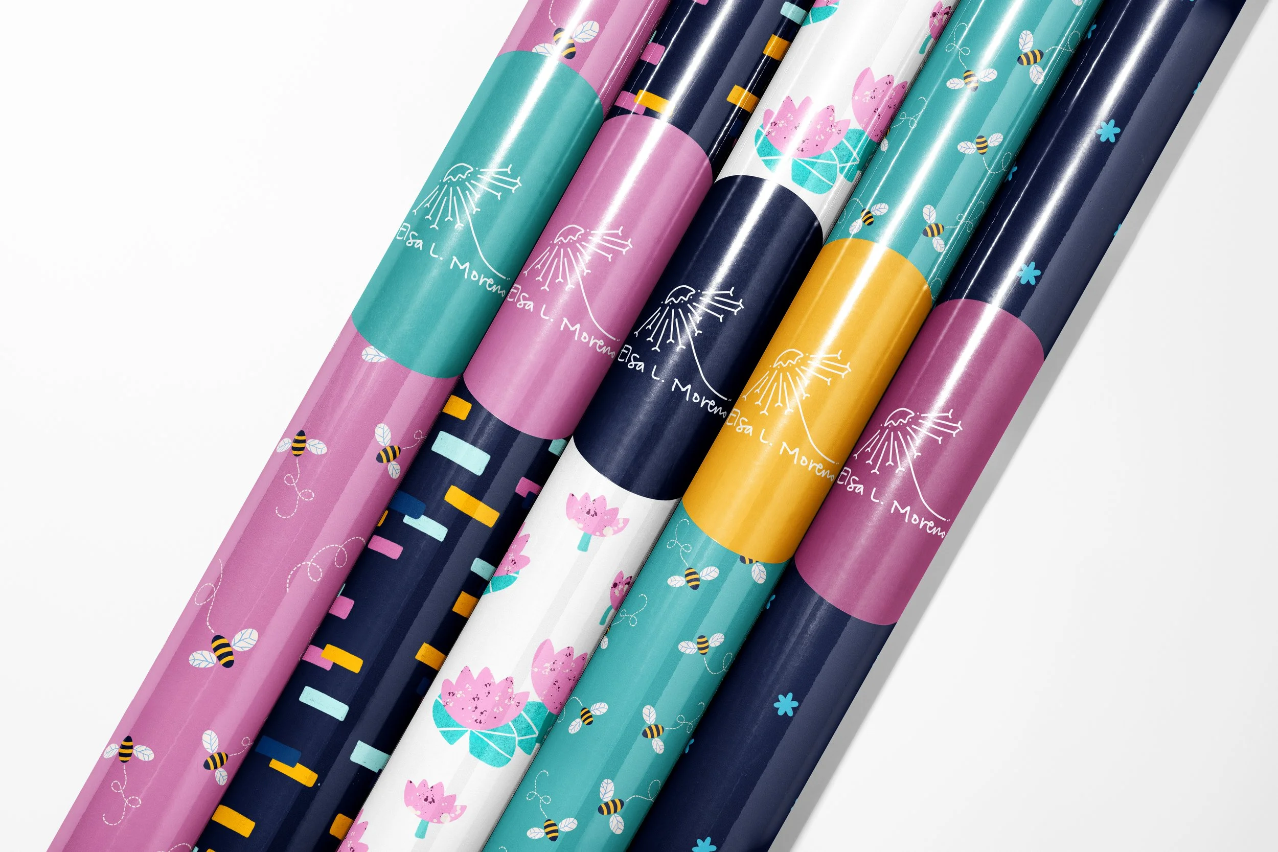 Five gift wrap paper rolls with colorful spring motifs