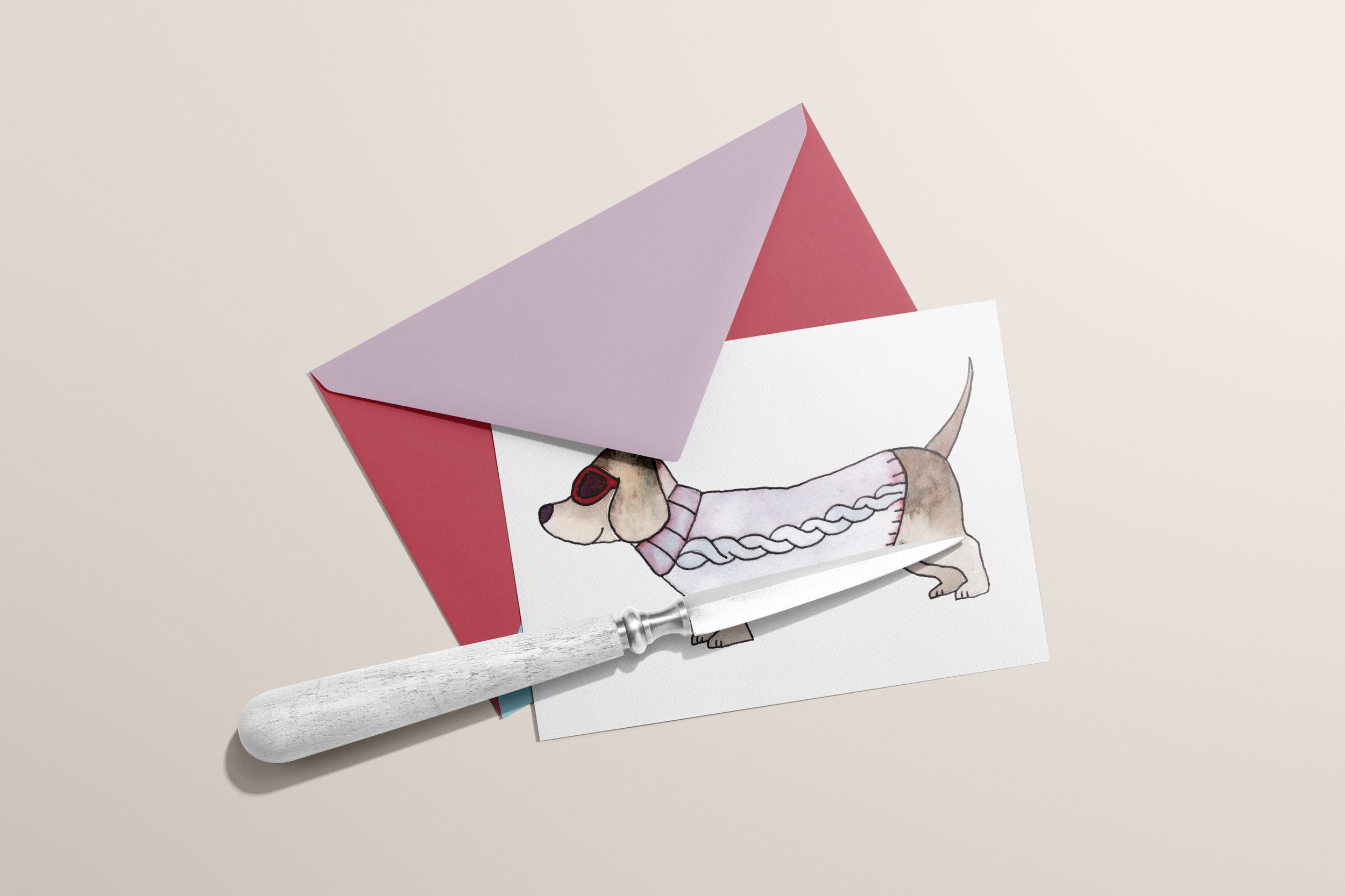 Card with envelope depicting a dachshund wearing a sweater and sunglasses