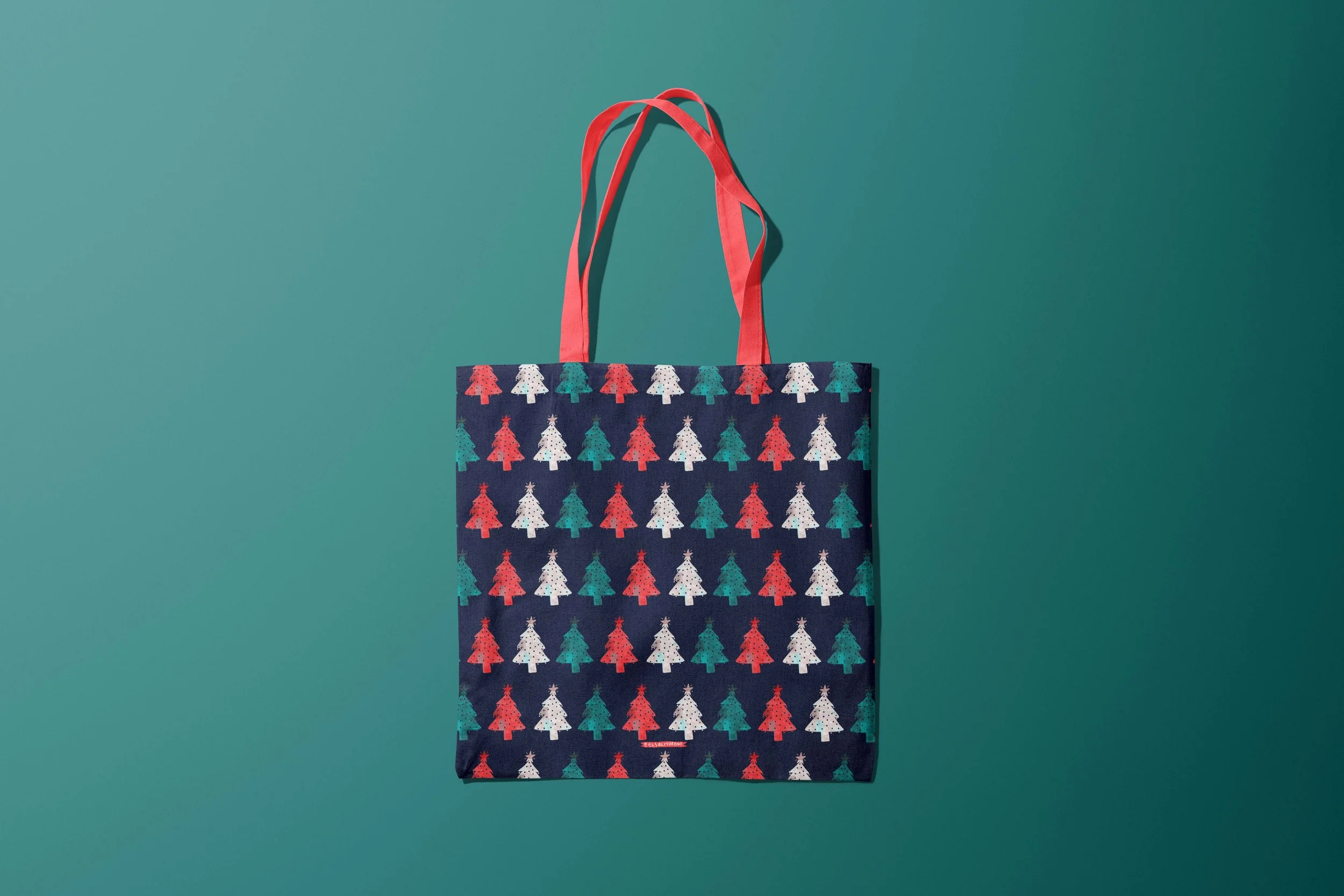Tote bag with a repeating pattern of Christmas trees in red, green and white, over a dark background