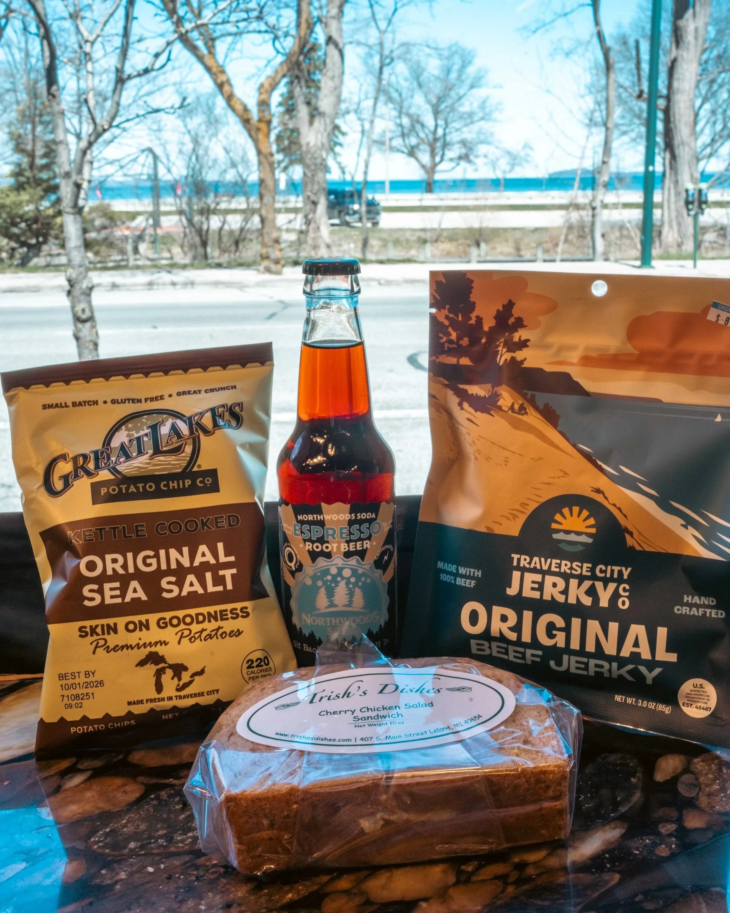 Local Traverse City food products with Grand Traverse Bay in the background
