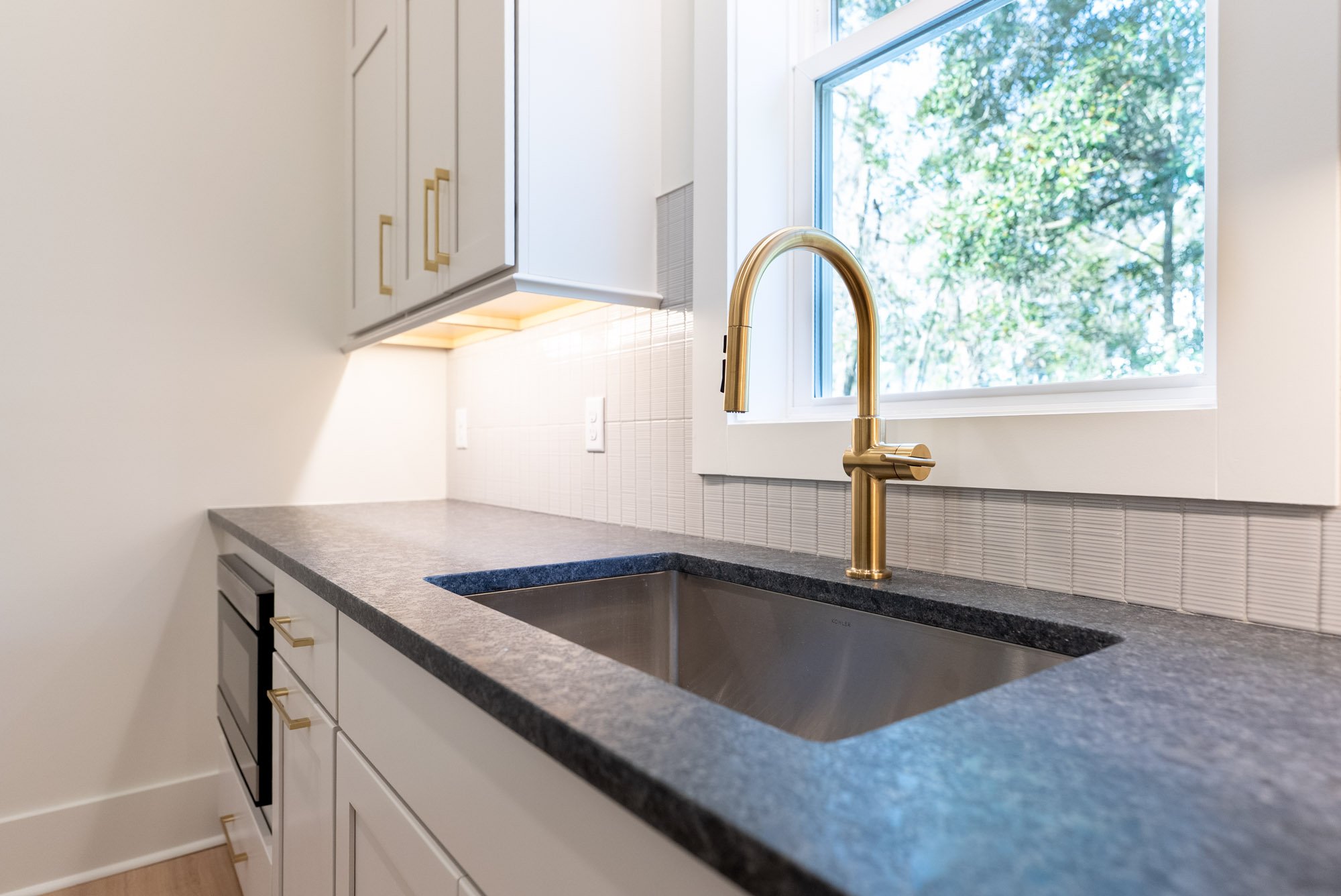 stainless steel kitchen sink with brushed gold hardware