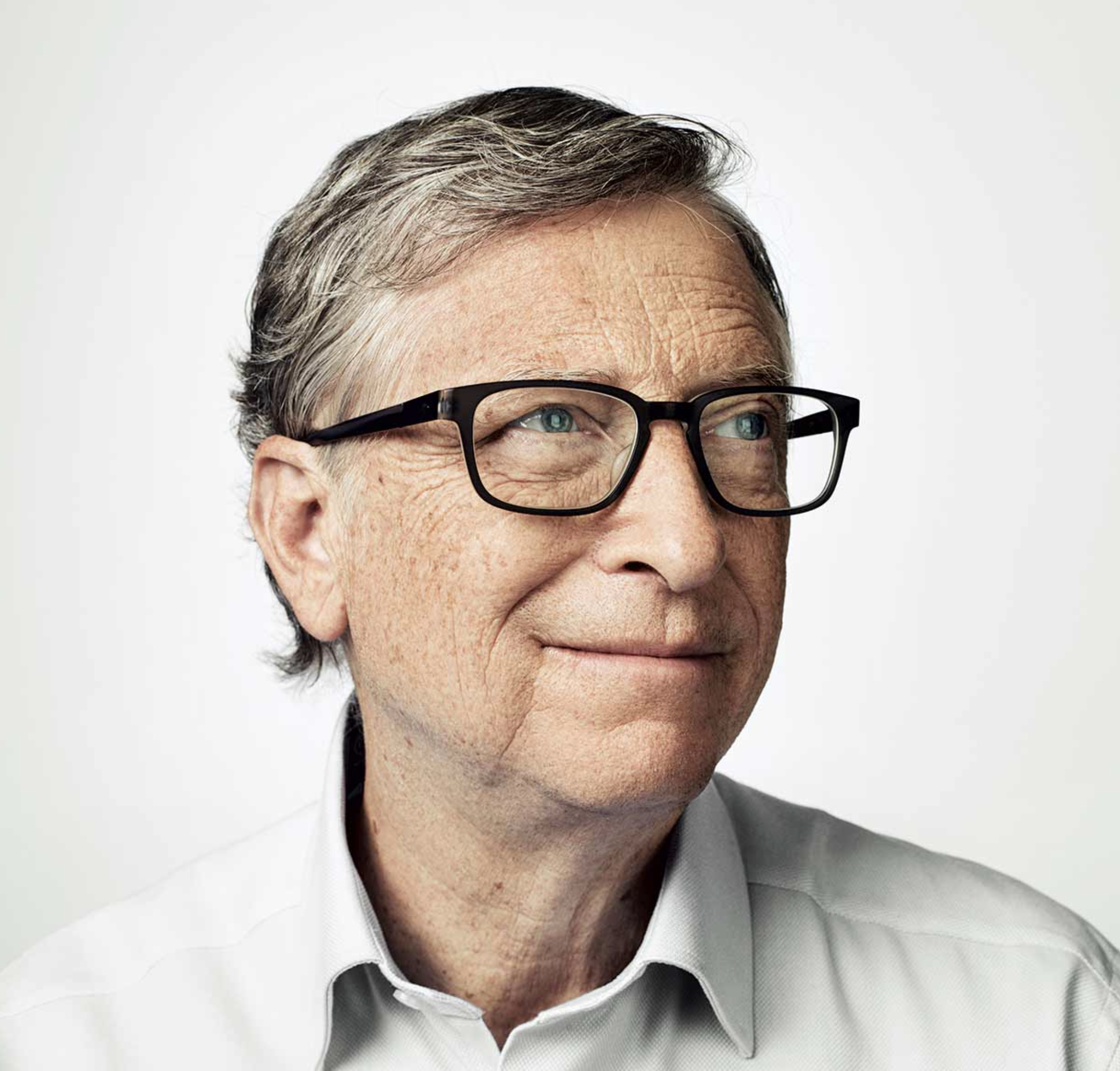Bill Gates with glasses and gray hair wearing a light-colored shirt, facing slightly to the side.