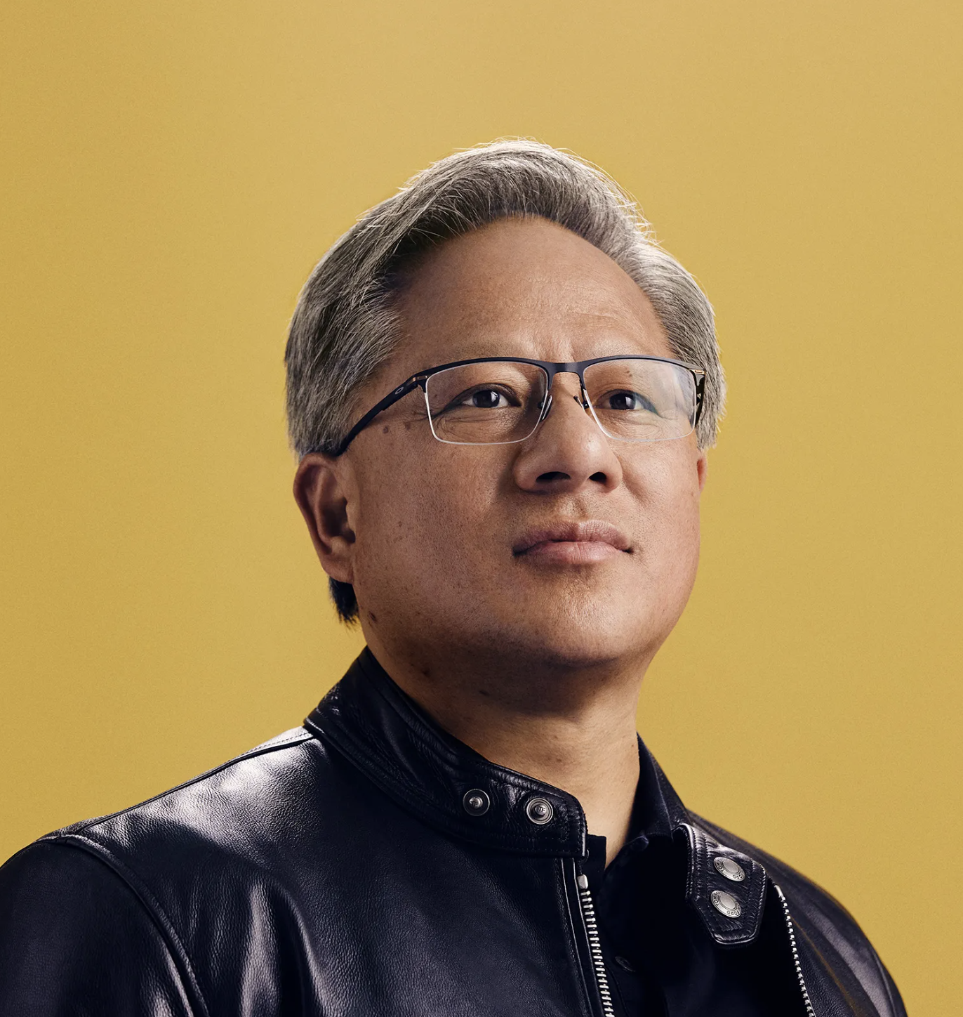 Jensen Huang wearing glasses and a leather jacket, set against a yellow background.