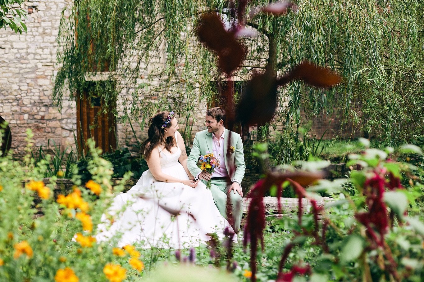 A picturesque DIY wedding at Radford Mill Farm, set against the backdrop of rolling hills, green space and beautifully maintained gardens - perfect for couple photos!

The ceremony took place under the trees, followed by garden photos, and a moment's