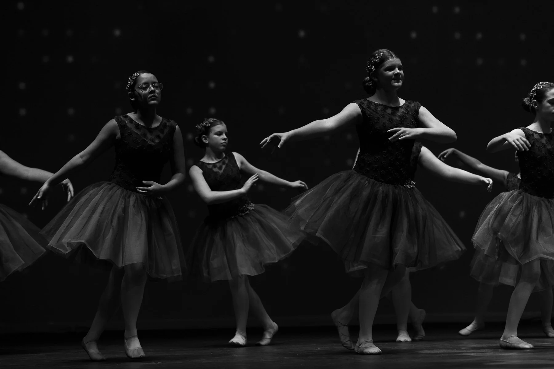 Black and white photo of preteen ballet dancers on stage