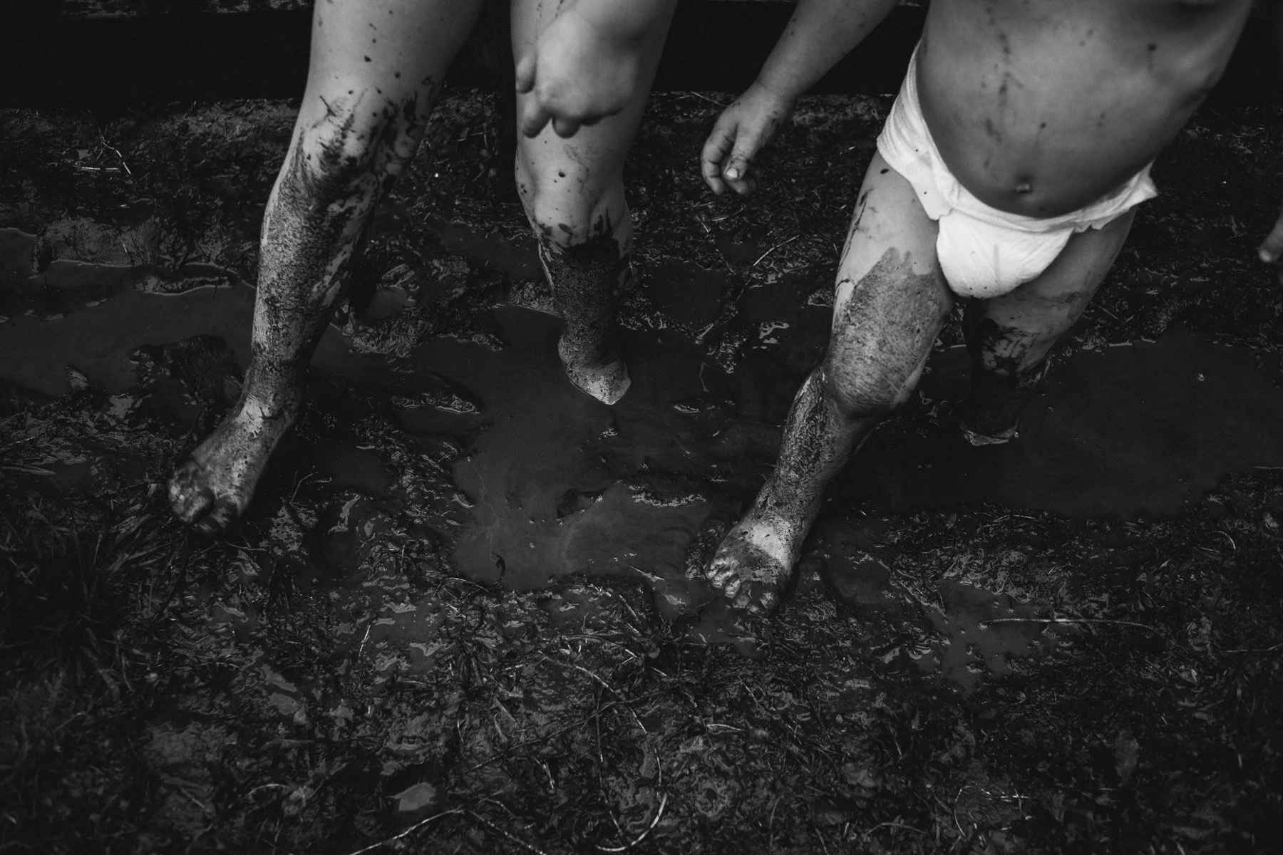 Kids feet covered in mud