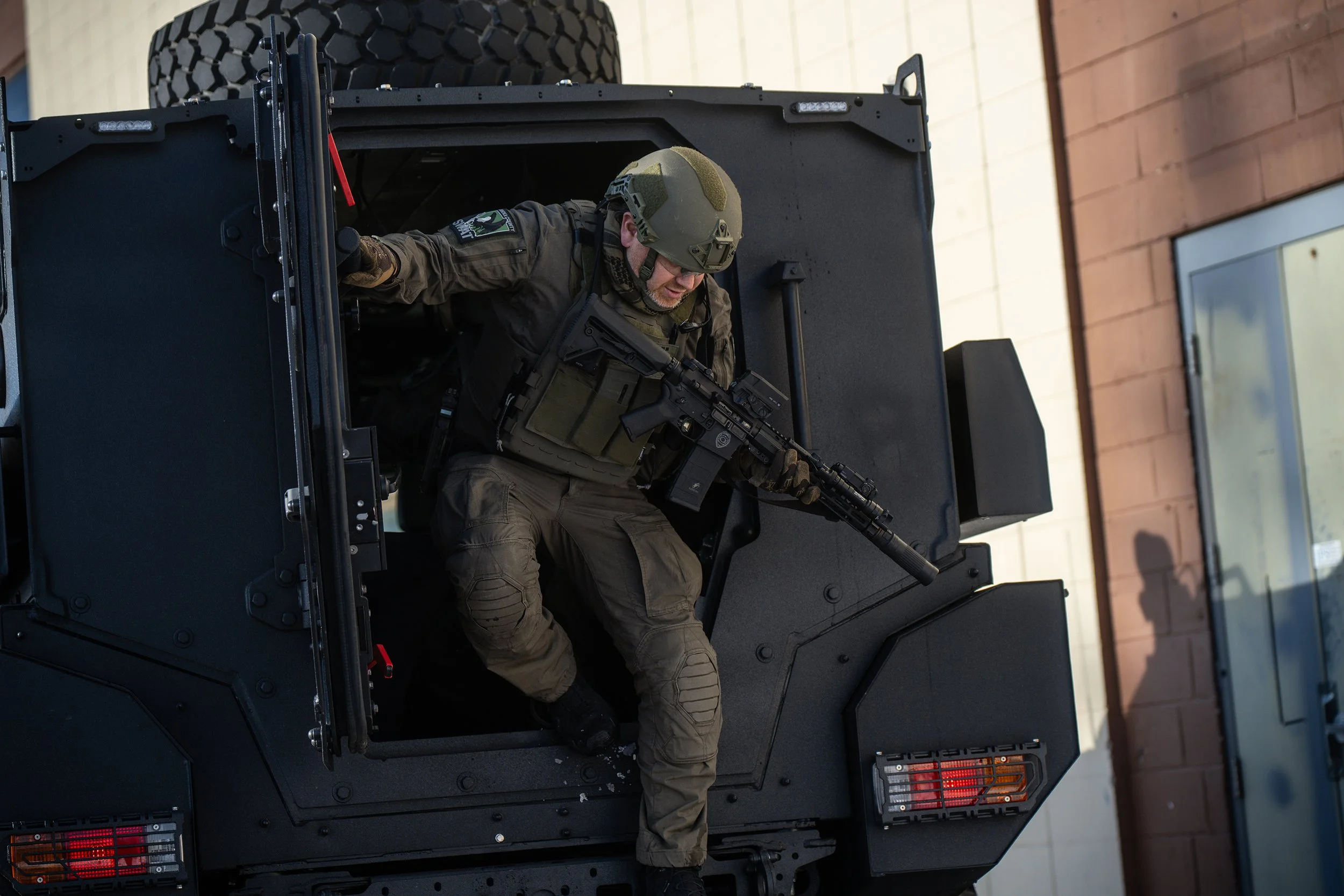 SWAT team maneuvering around Renegade APC