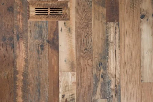 Close-up of a wooden floor with a vent near the top.