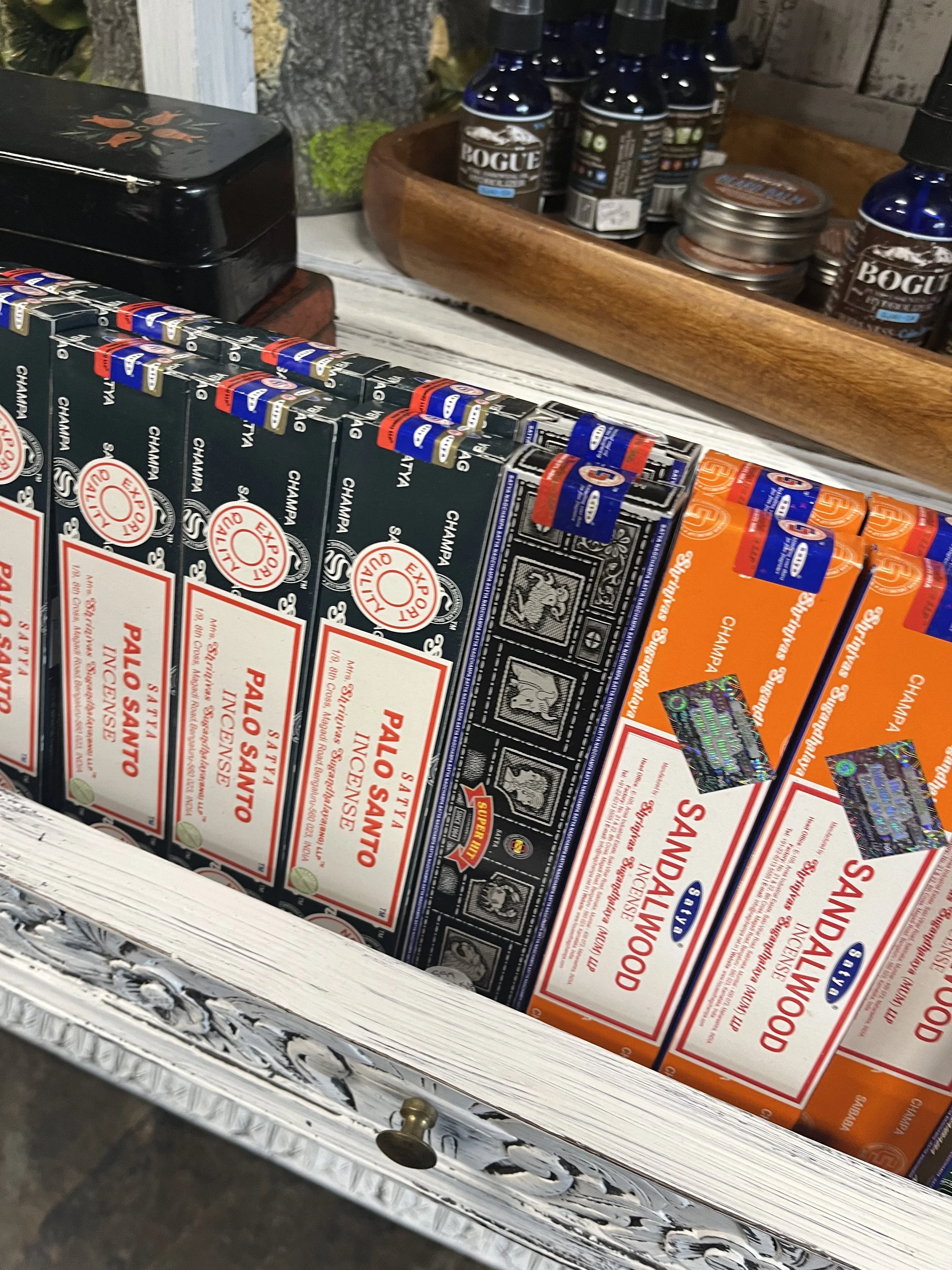 Boxes of Sankalanood incense sticks on a display shelf.