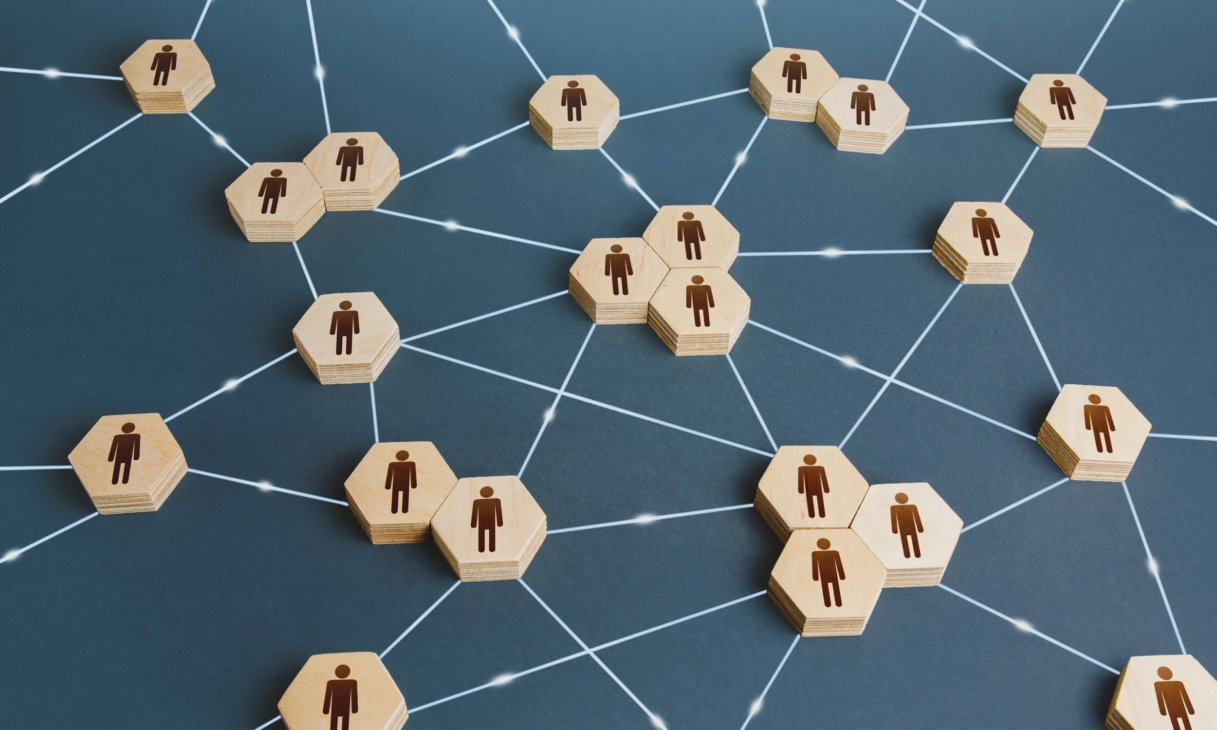 Image showing interconnected puzzle pieces with drawings on humans on them