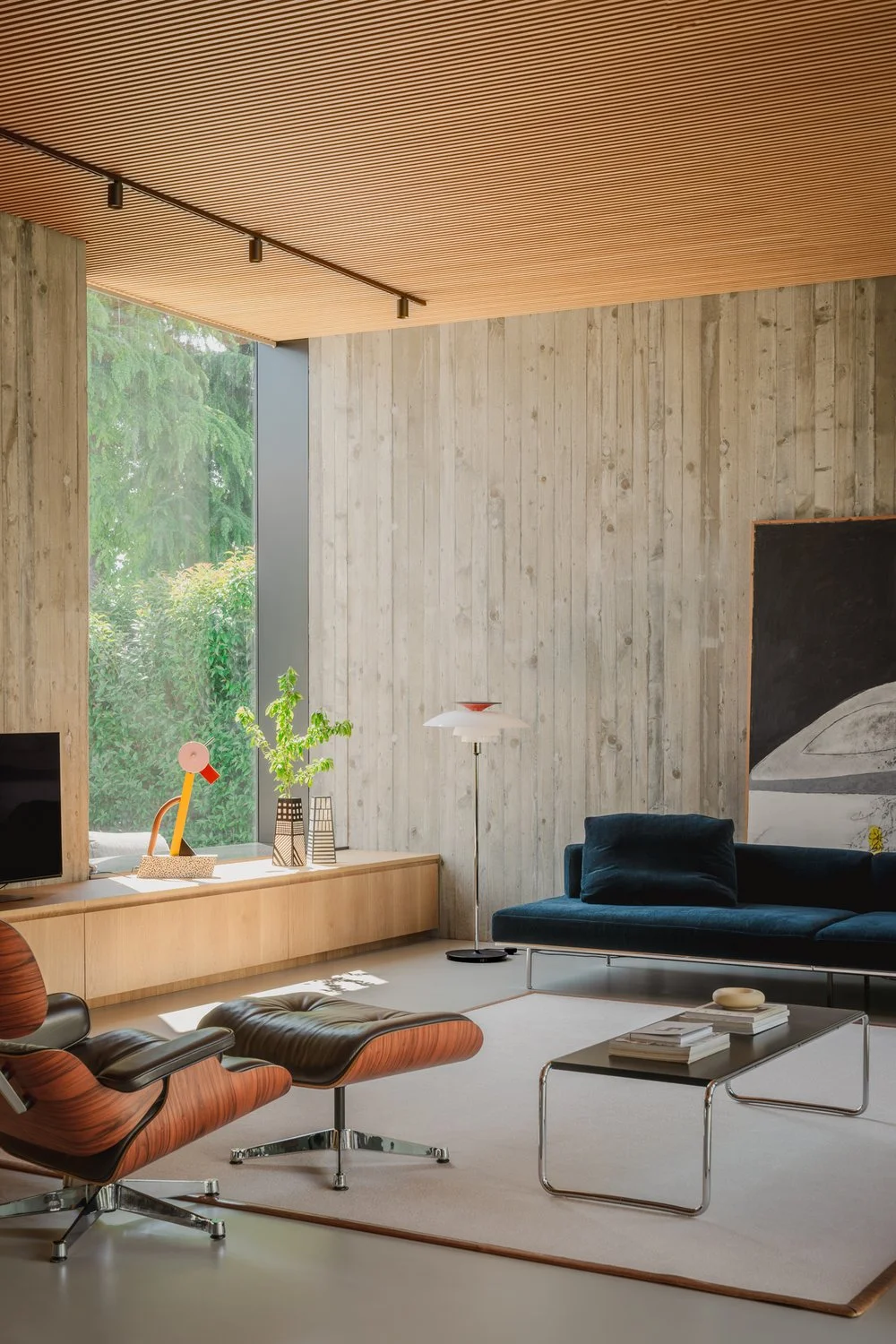Modern midcentury living room with classic eames armchairs