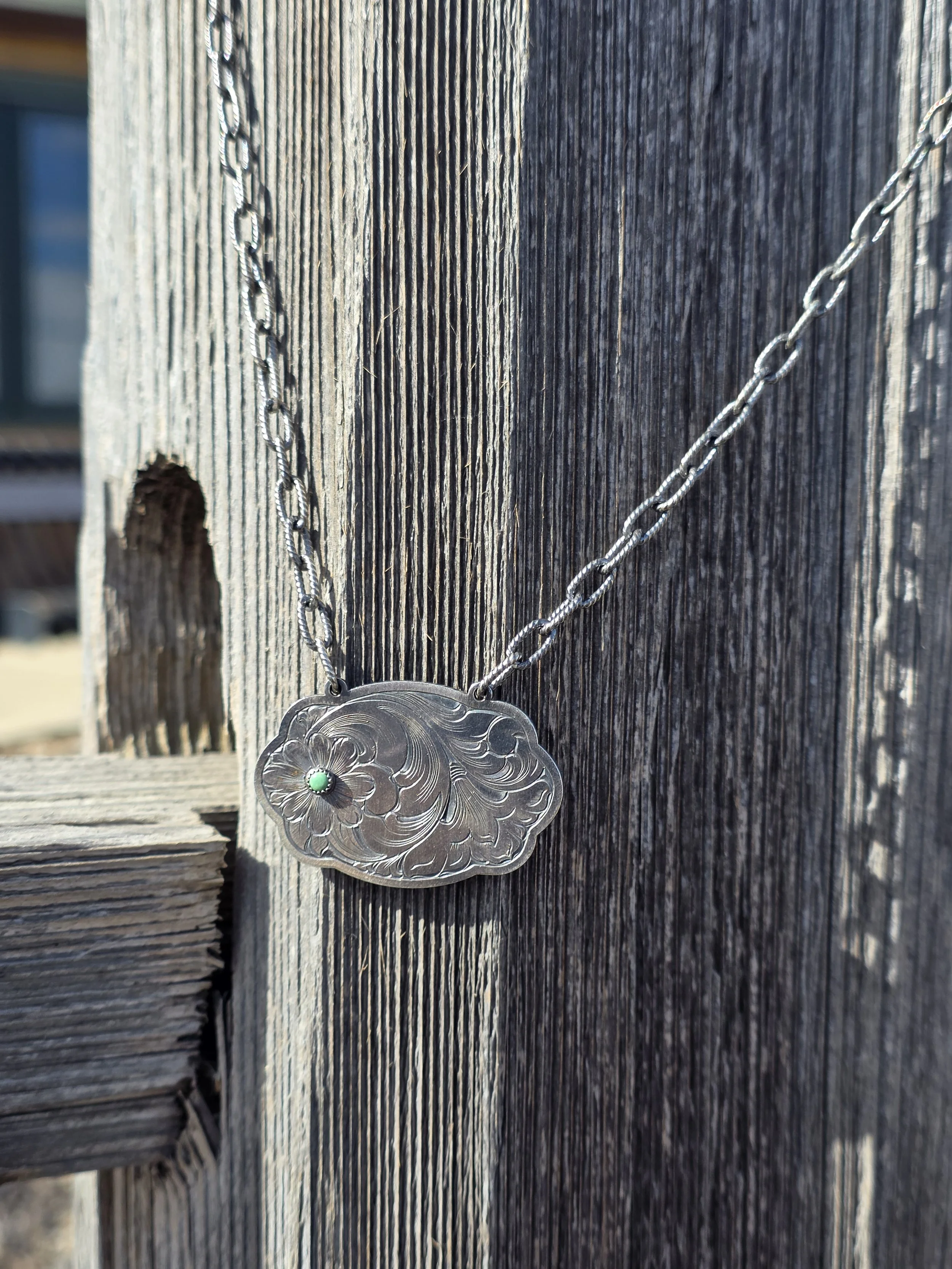 Sterling silver buckle necklace with small turquoise stone. Hand engraved.