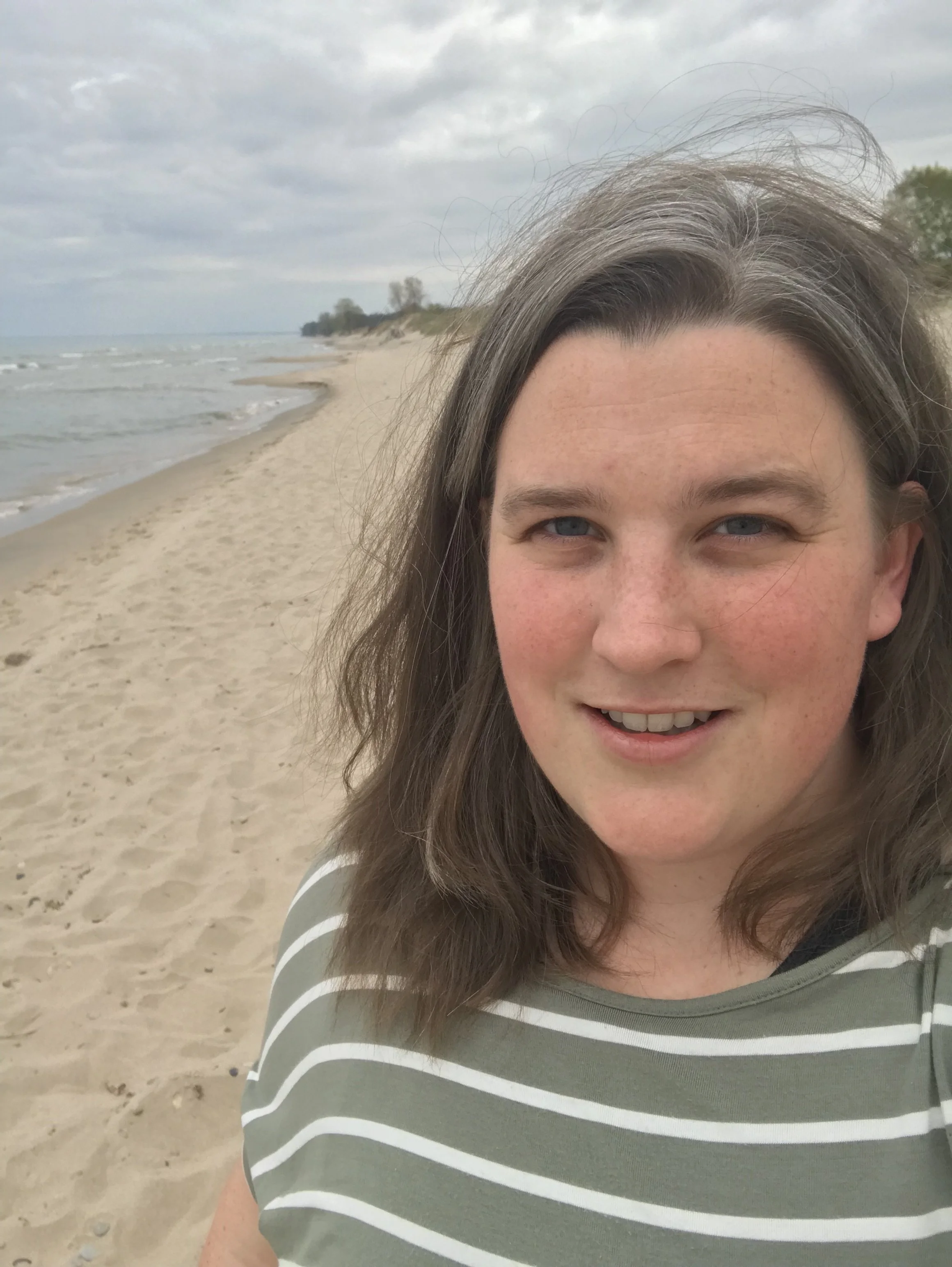 Up close image of Amy Mester on a sandy beach.