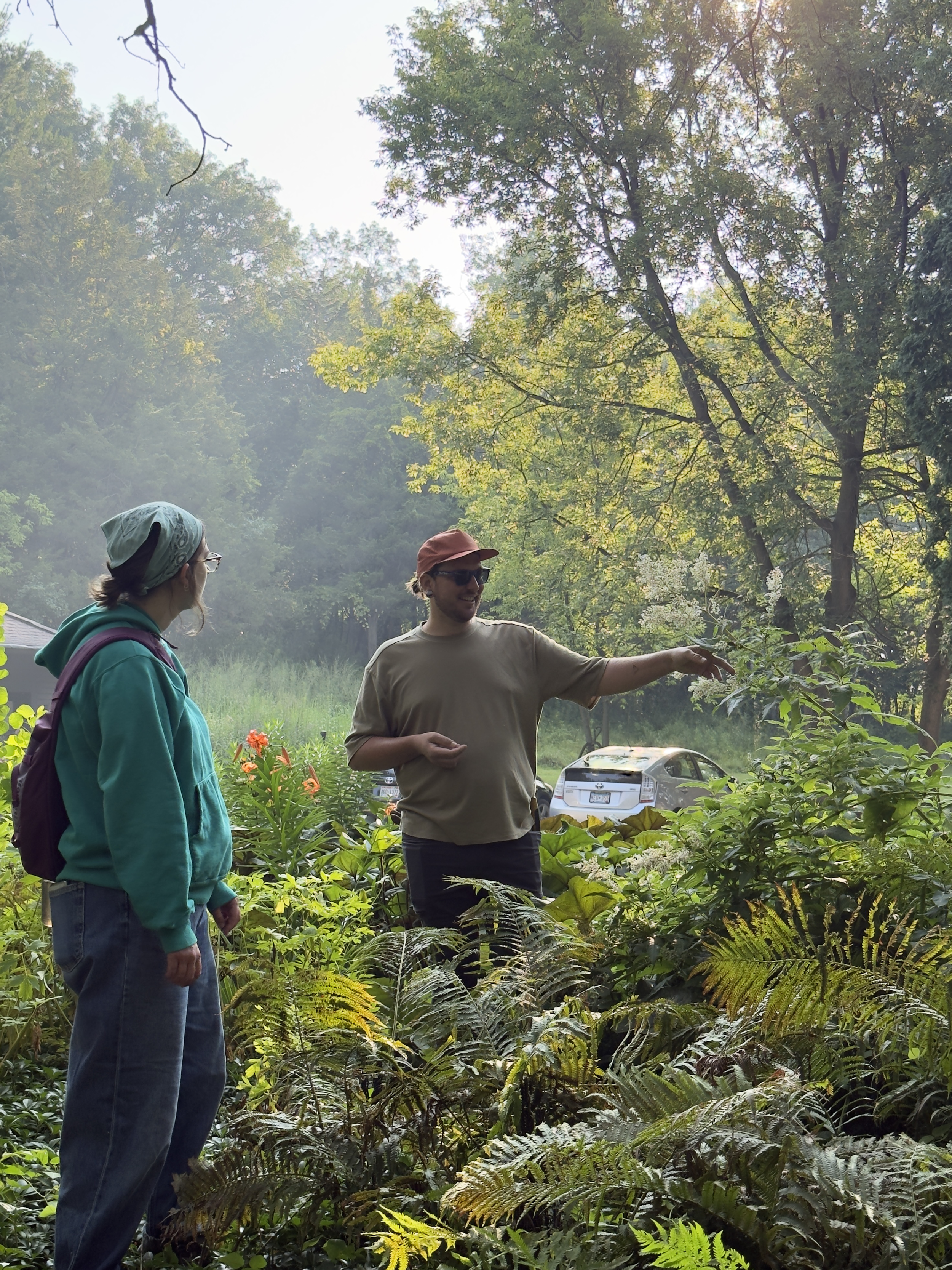Image of Alex M. Petersen in the tall ferns with a student