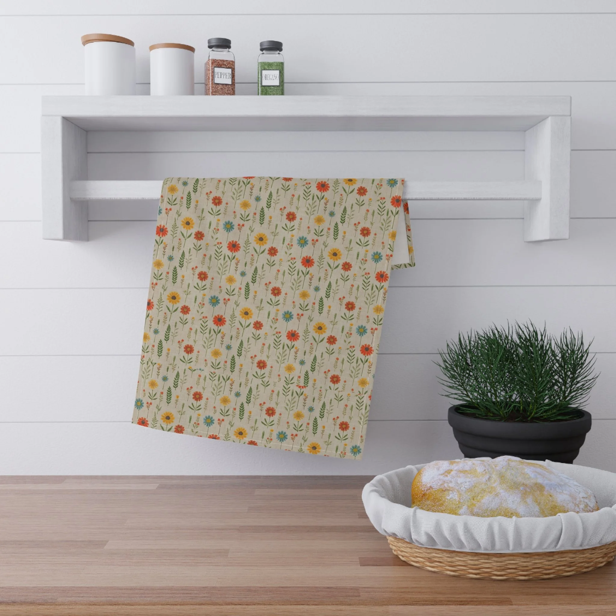 hanging “Spring March” kitchen towel. with small, colorful flowers