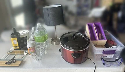 Various soap making supplies and equipment on a table