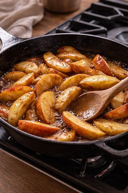 apples cooking in an iron skillet on the stovetop