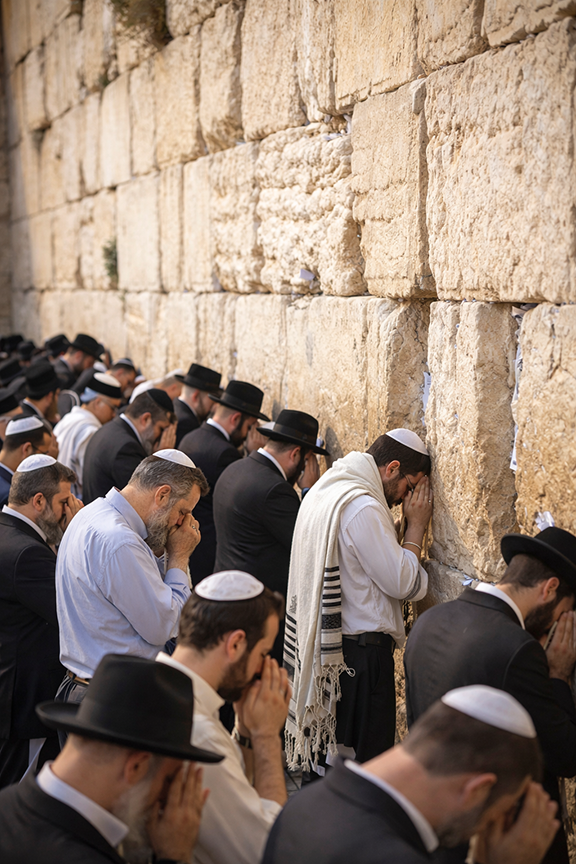 Men praying at the Western Wall in Jerusalem
