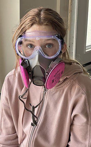 teenage girl with goggles and respirator