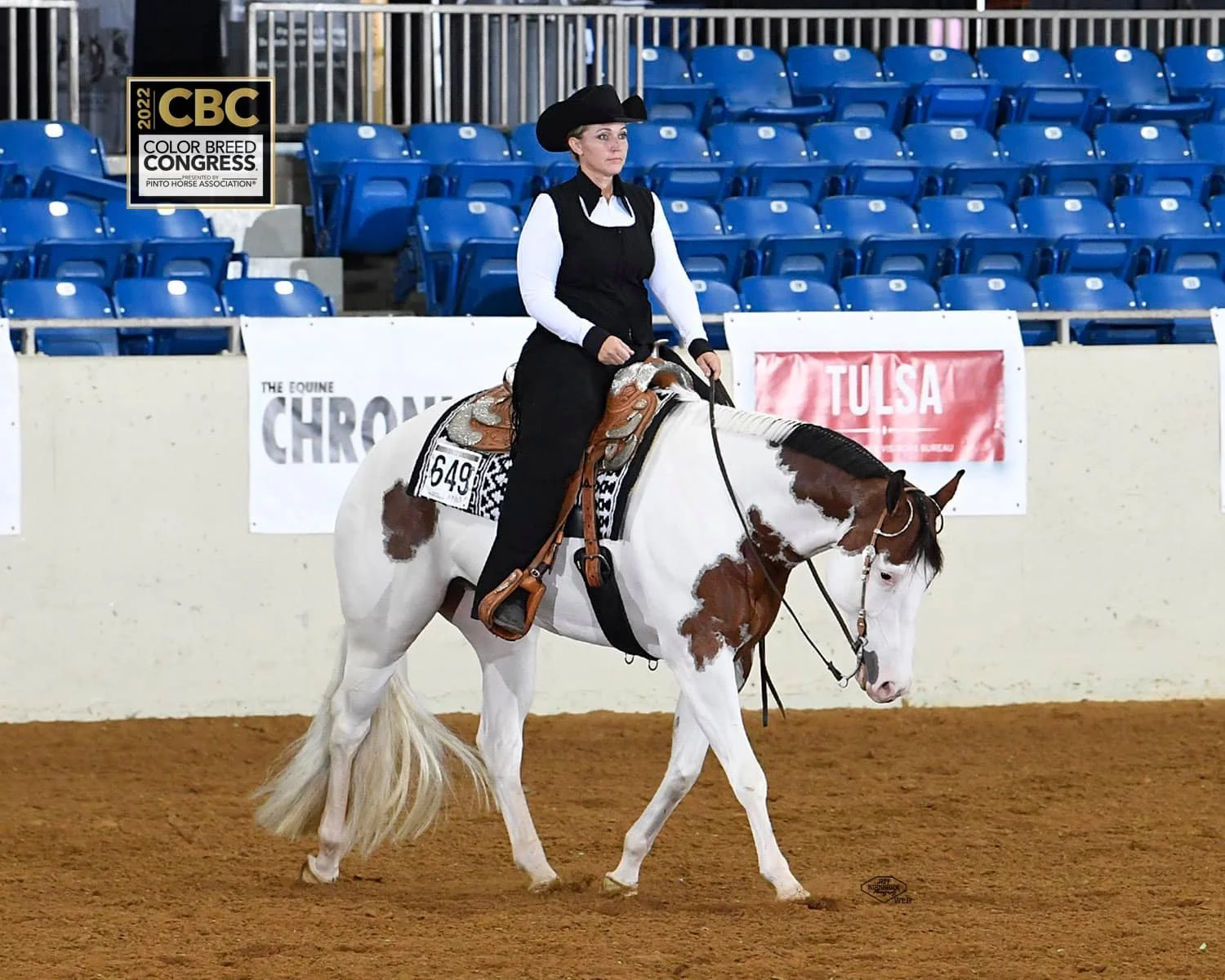 Equestrian rider on a paint horse at 2022 Color Breed Congress, indoor arena.