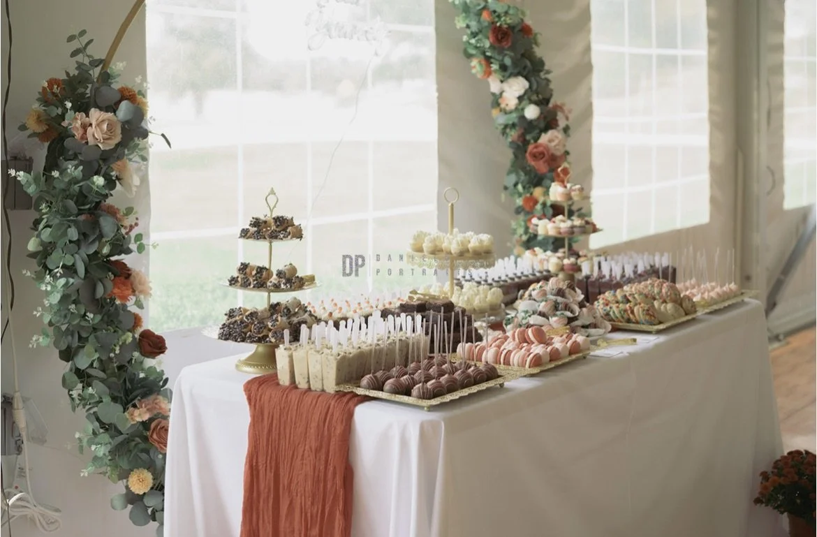 Wedding dessert table display with floral décor and decorative rental pieces for an elegant reception.